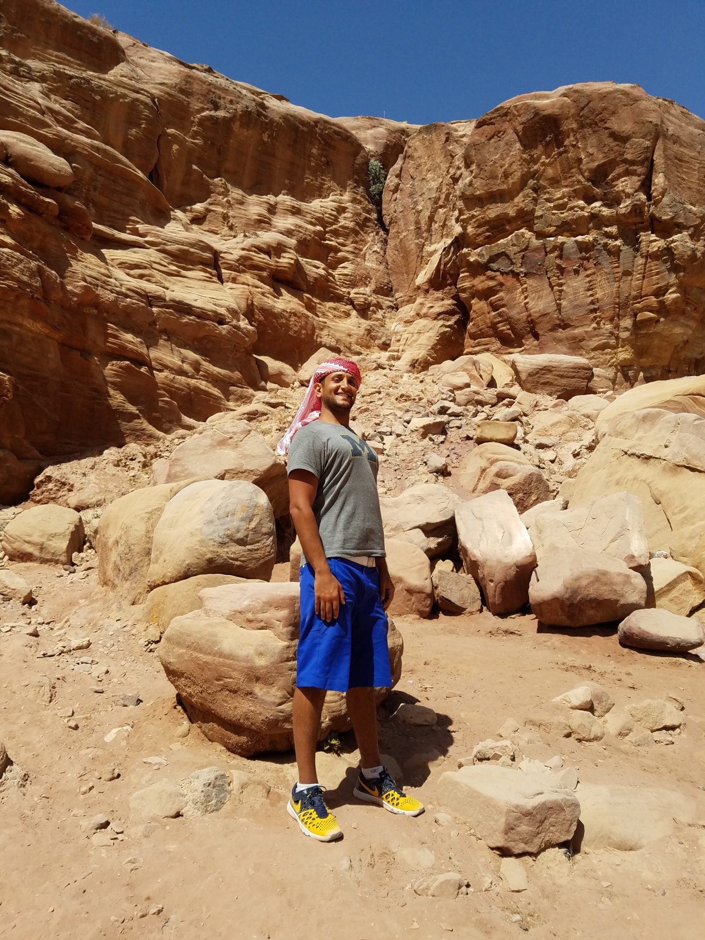 a man standing in a rocky area
