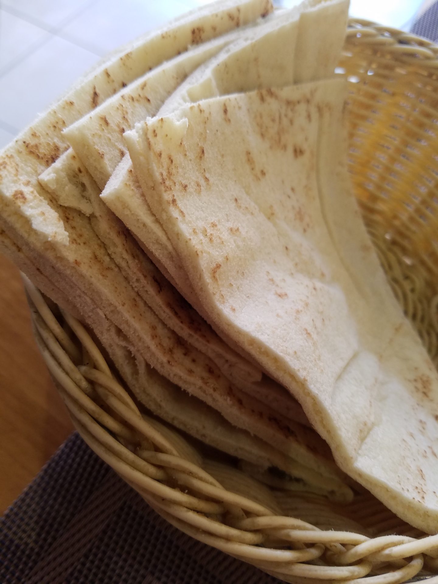 a stack of tortillas in a basket