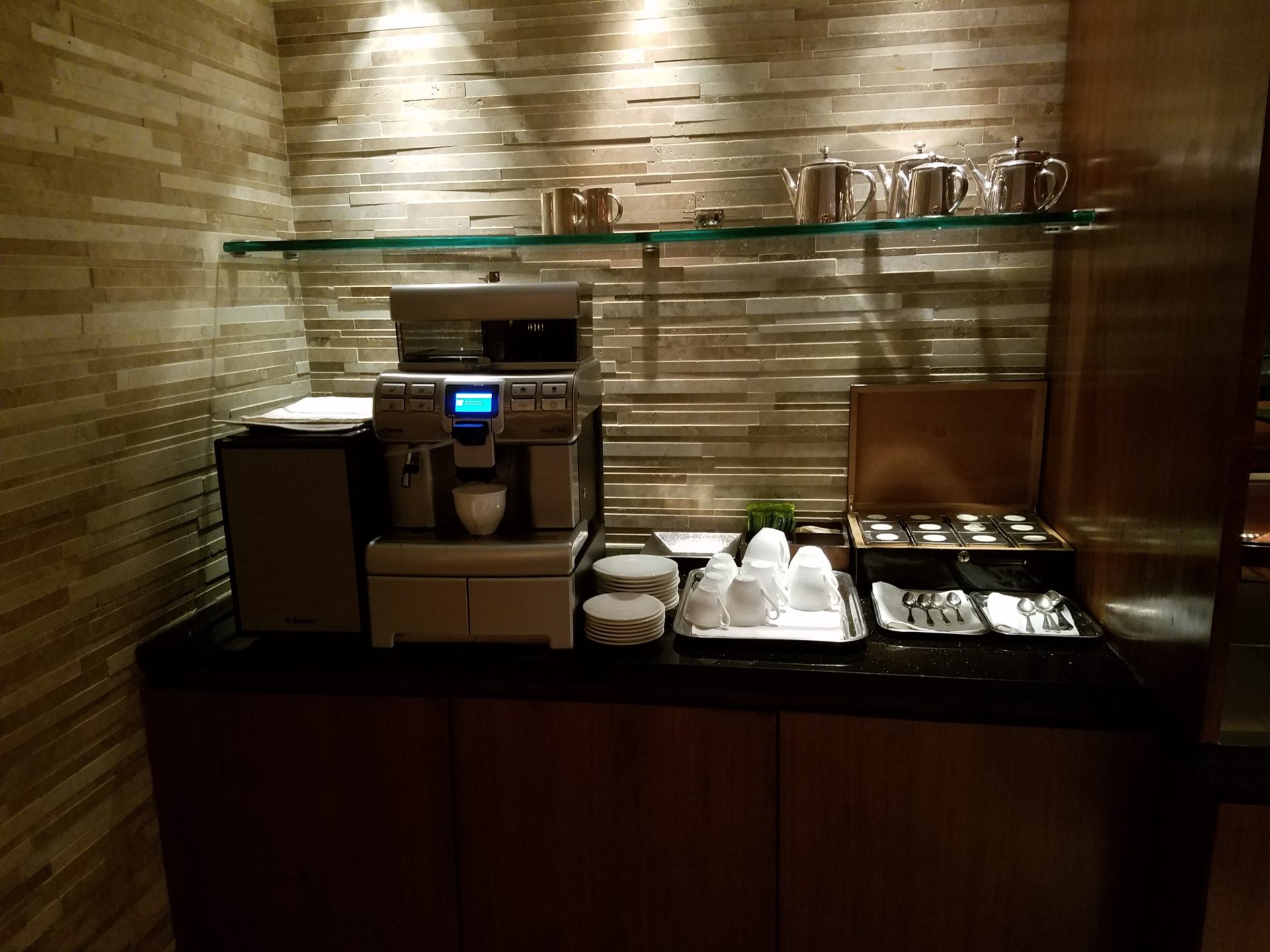 a coffee machine and utensils on a counter