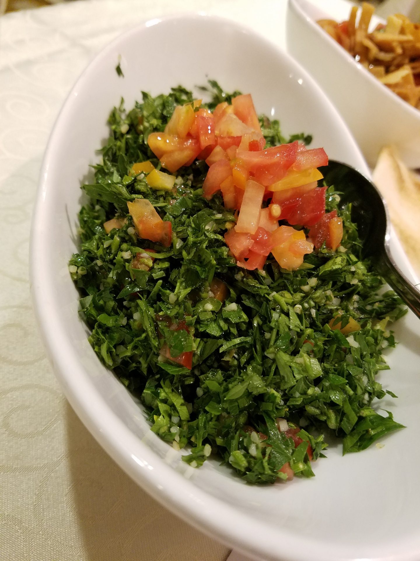 a bowl of salad with tomatoes and greens