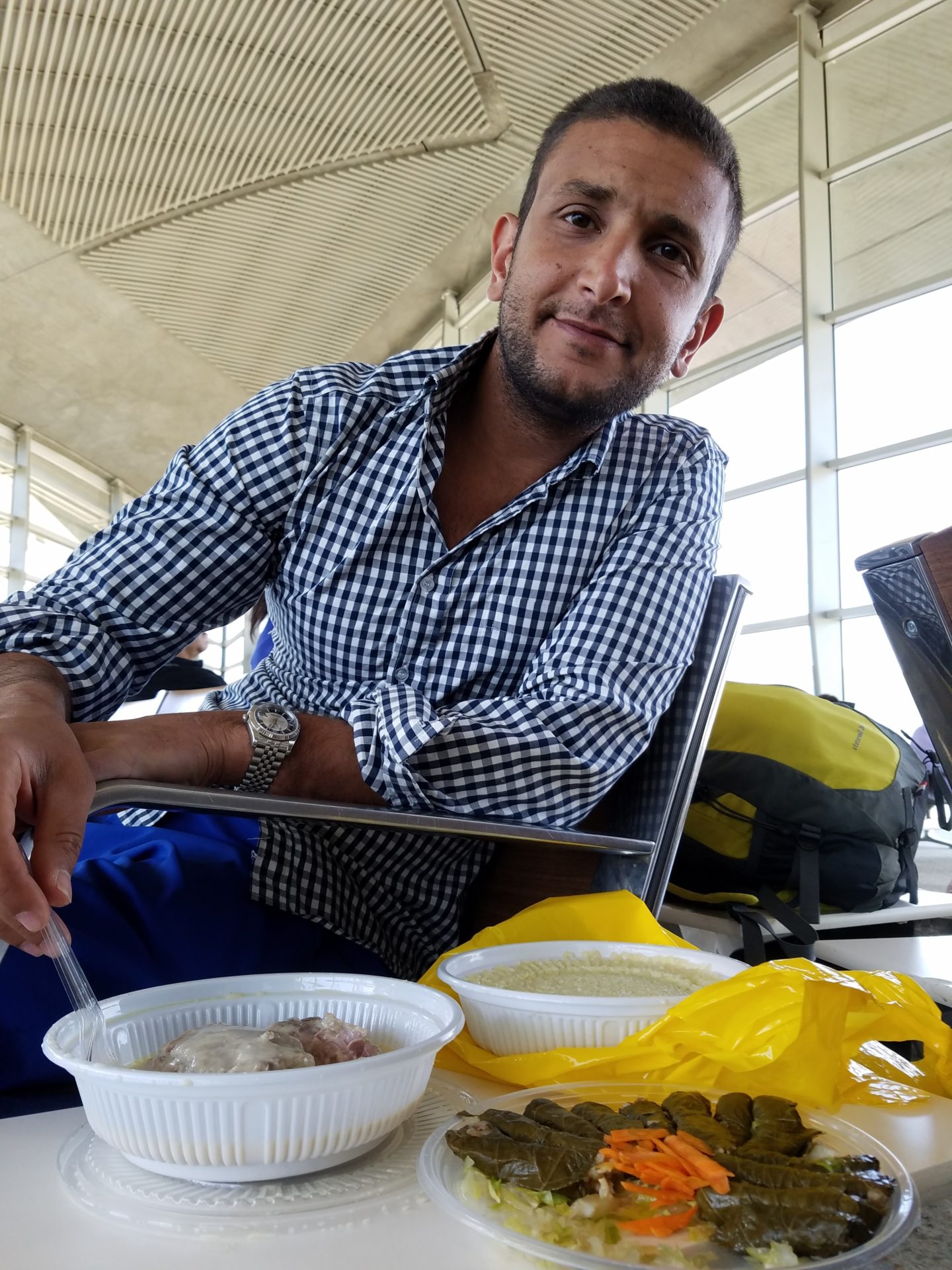 a man sitting at a table with food