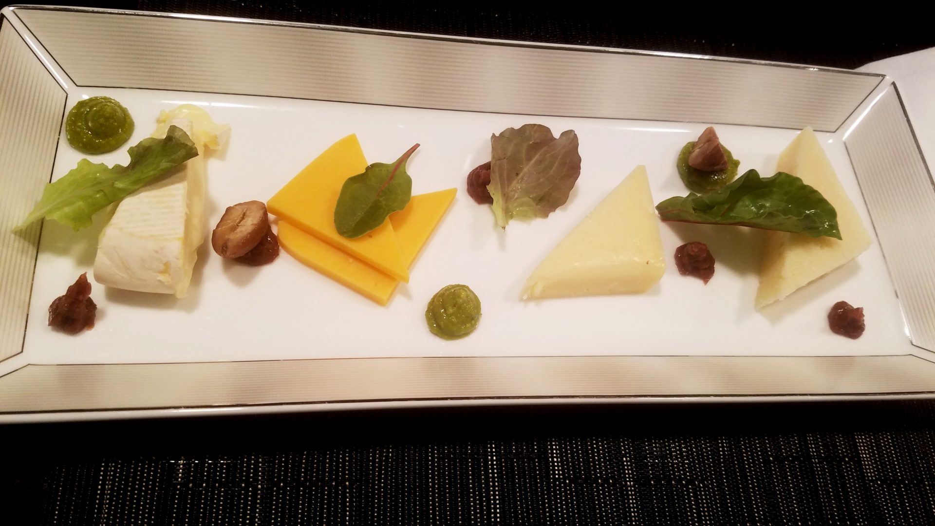 a plate of cheese and other food