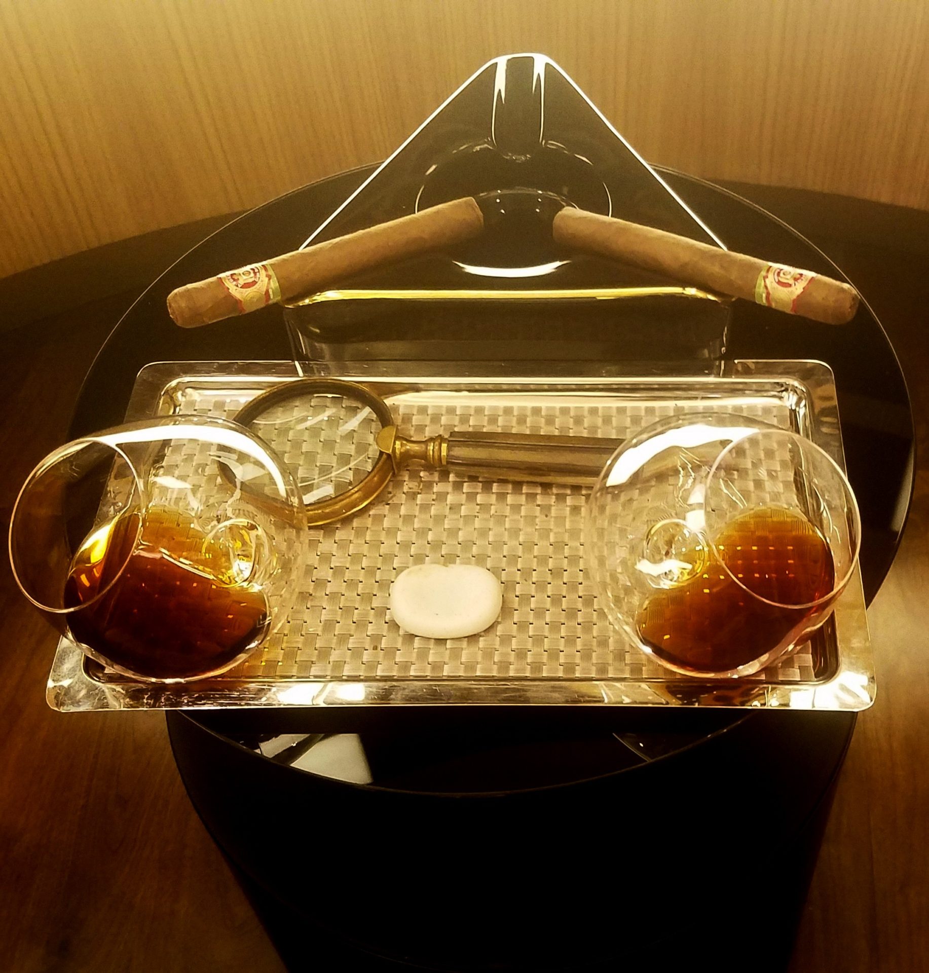 a cigars and glasses on a tray