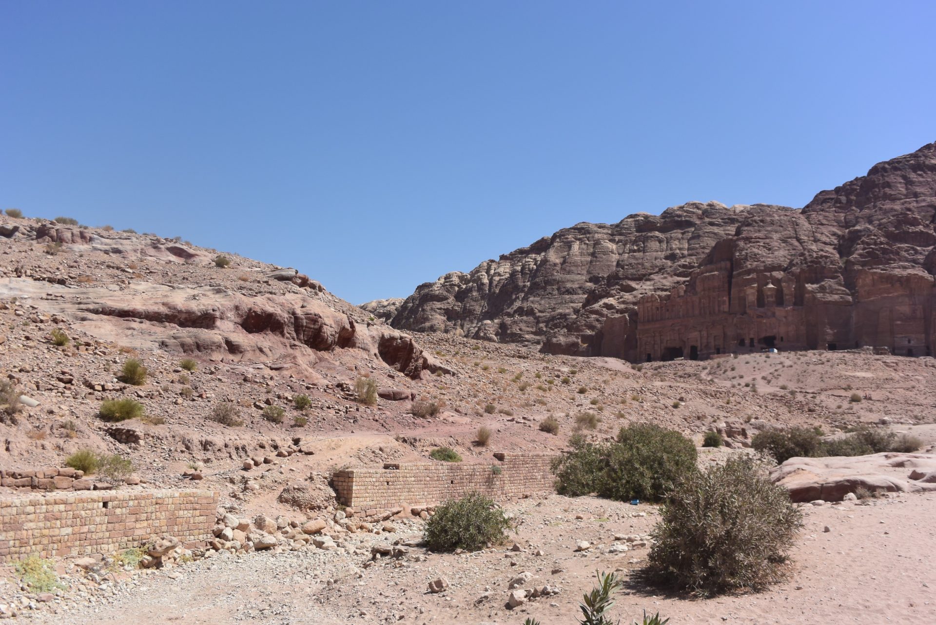 a rocky landscape with a building in the middle