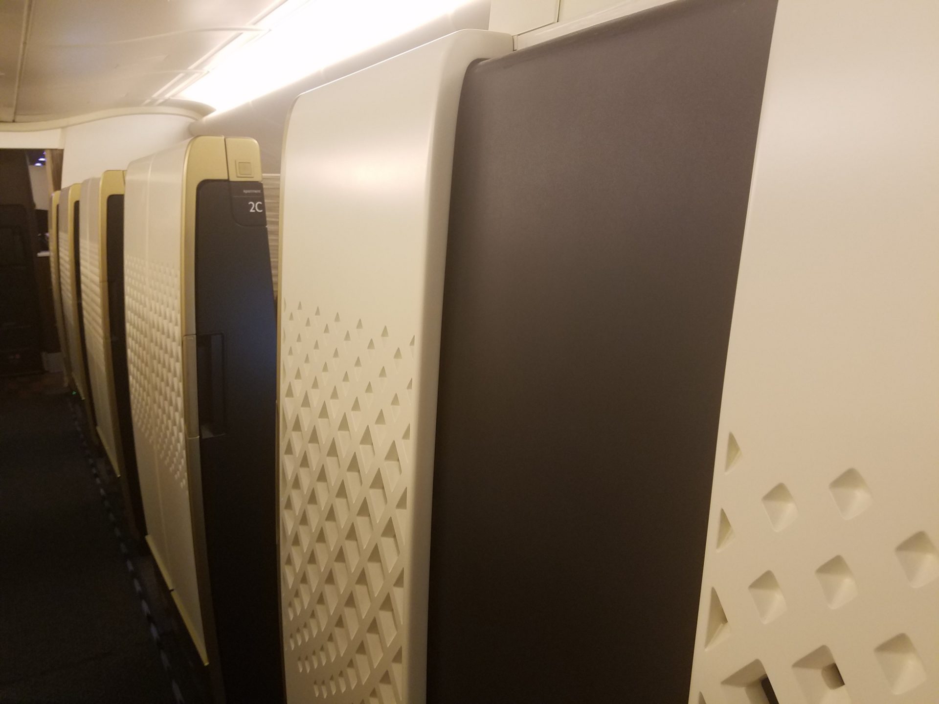 a row of white and black refrigerators