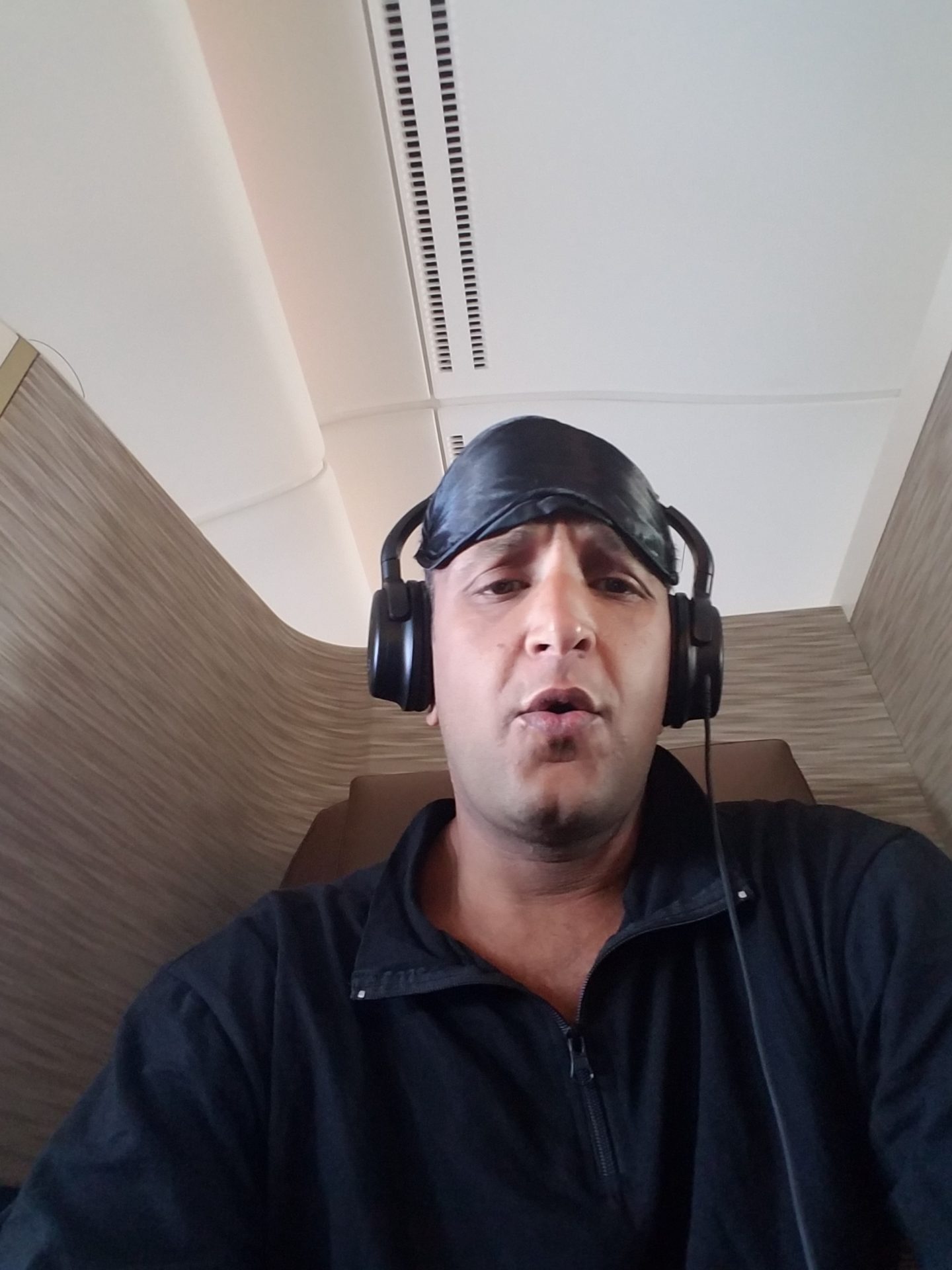 a man wearing headphones and a sleeping mask