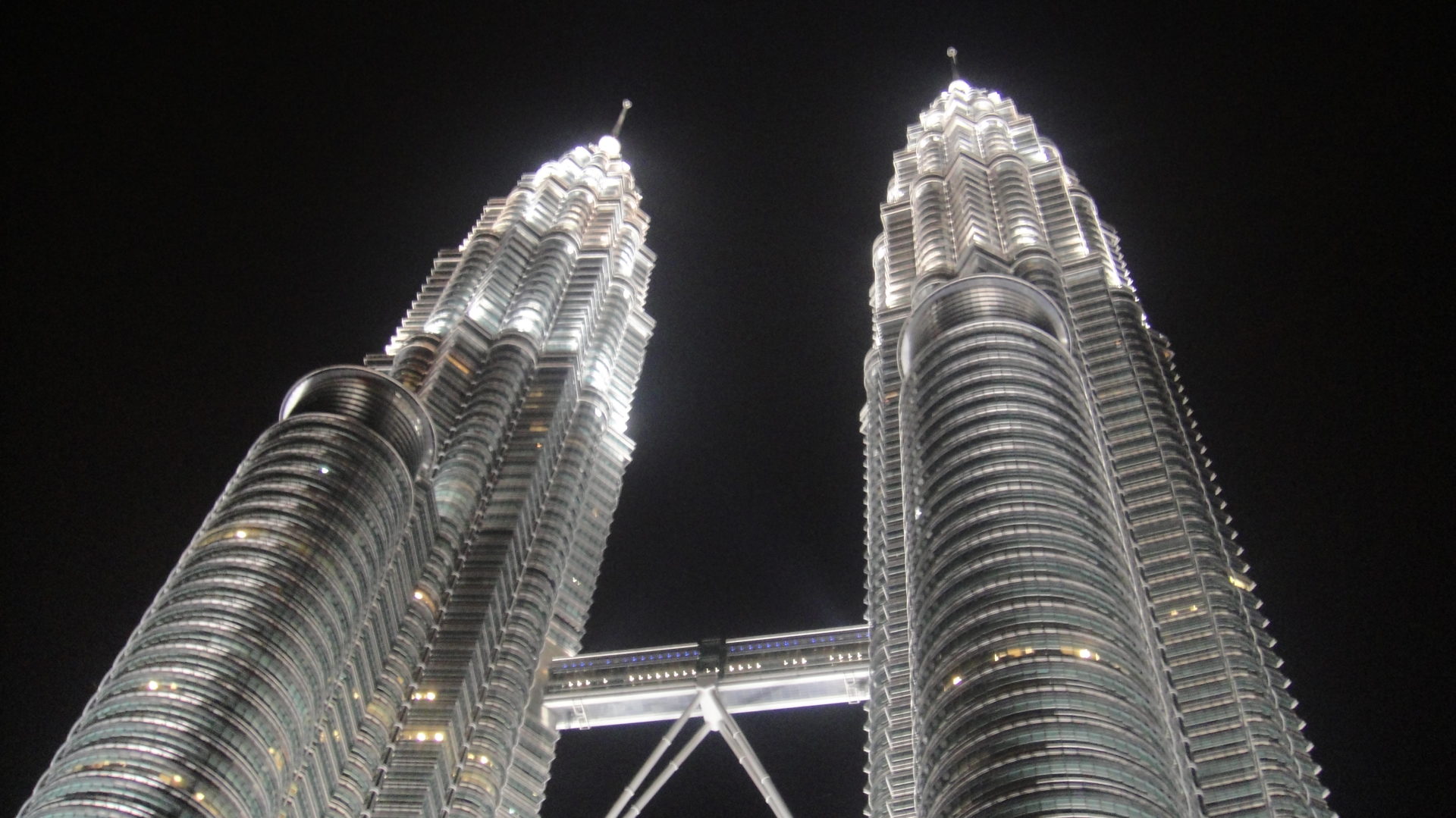a two tall buildings with Petronas Towers