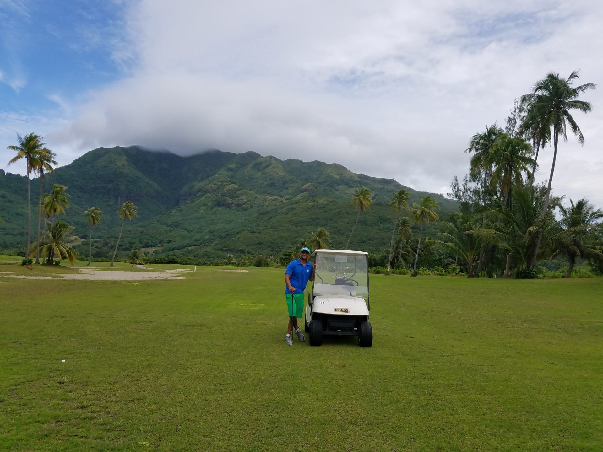 a man standing next to a golf cart
