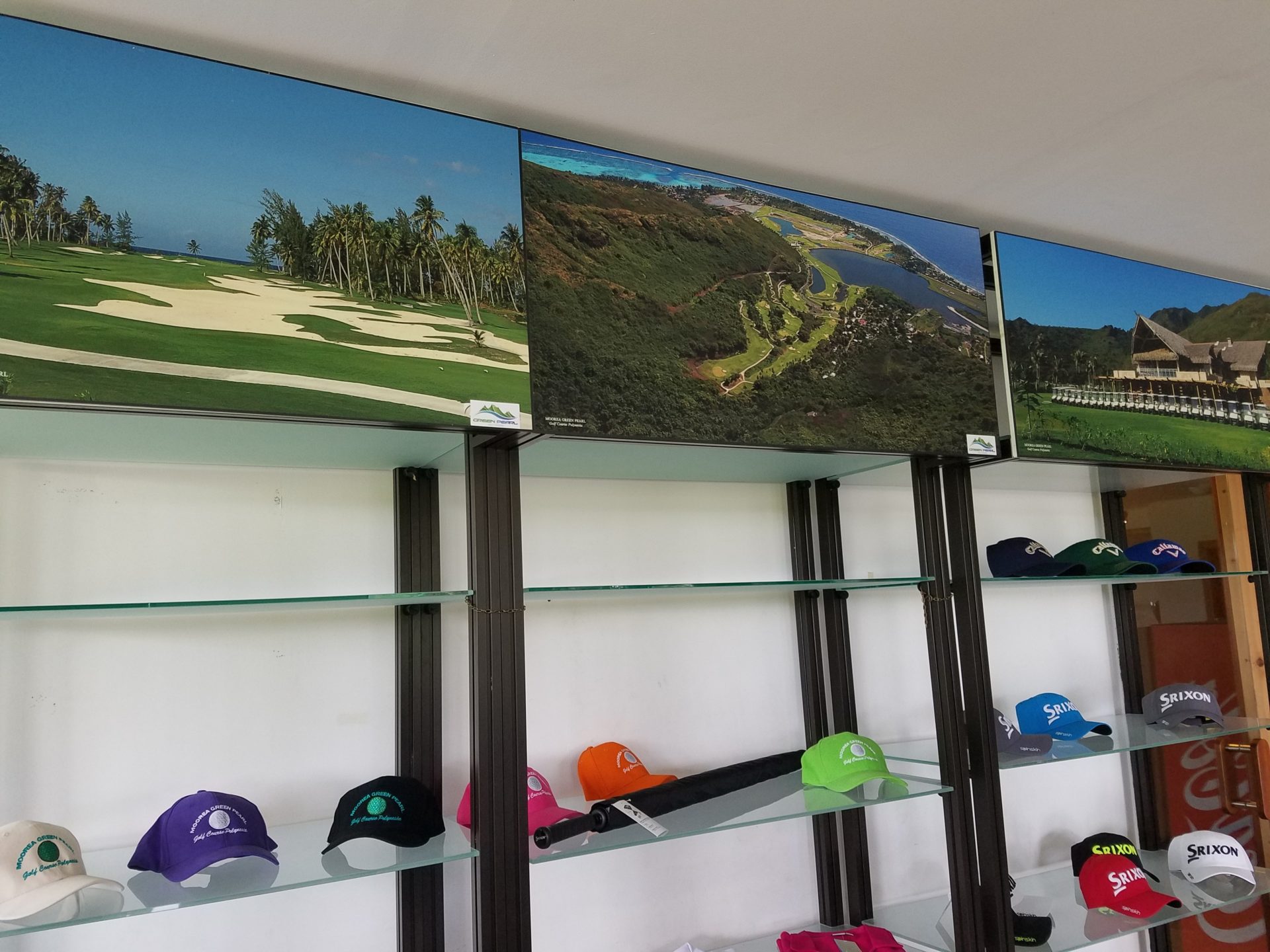 a display of golf caps on shelves