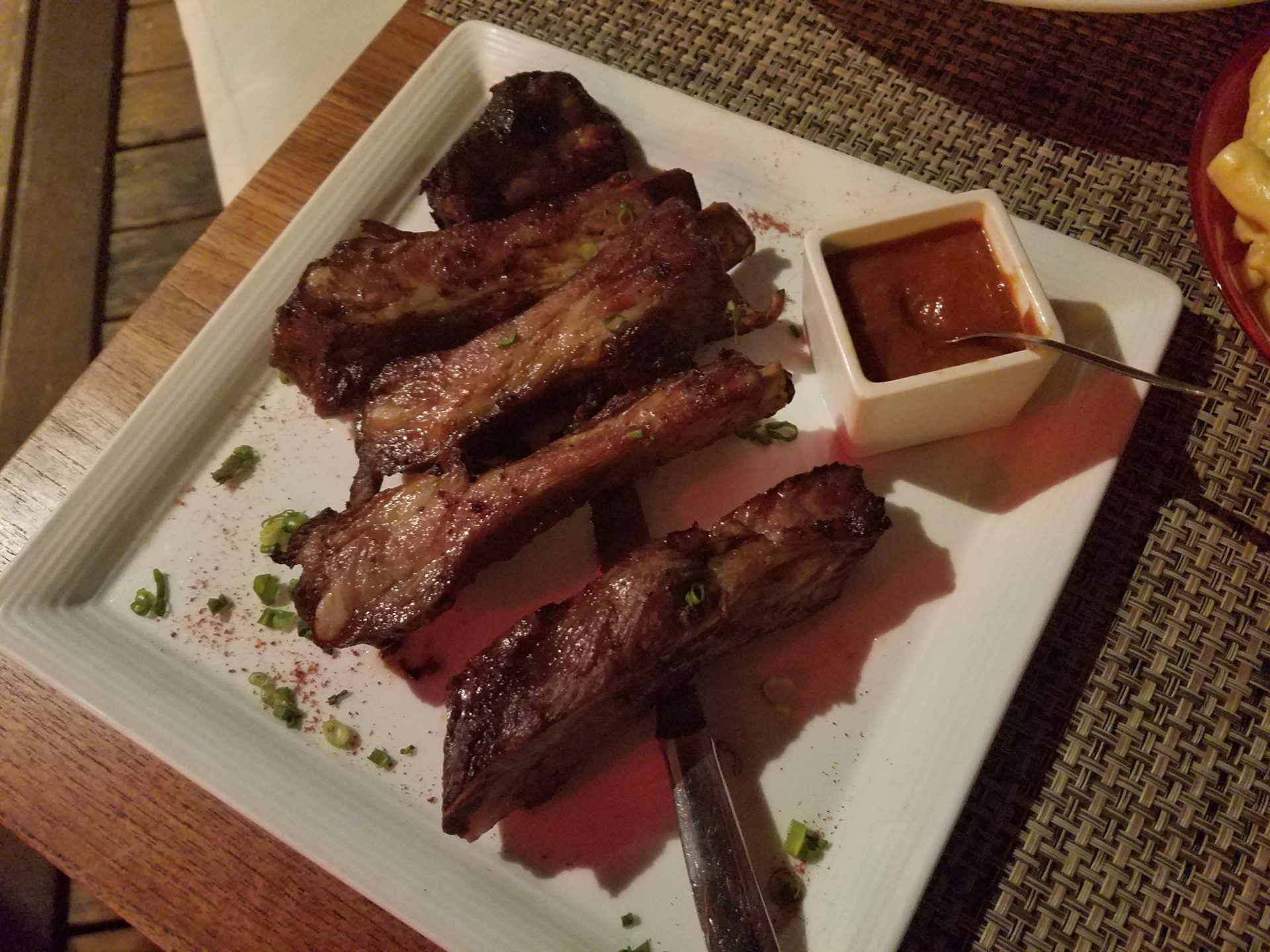 a plate of ribs with sauce