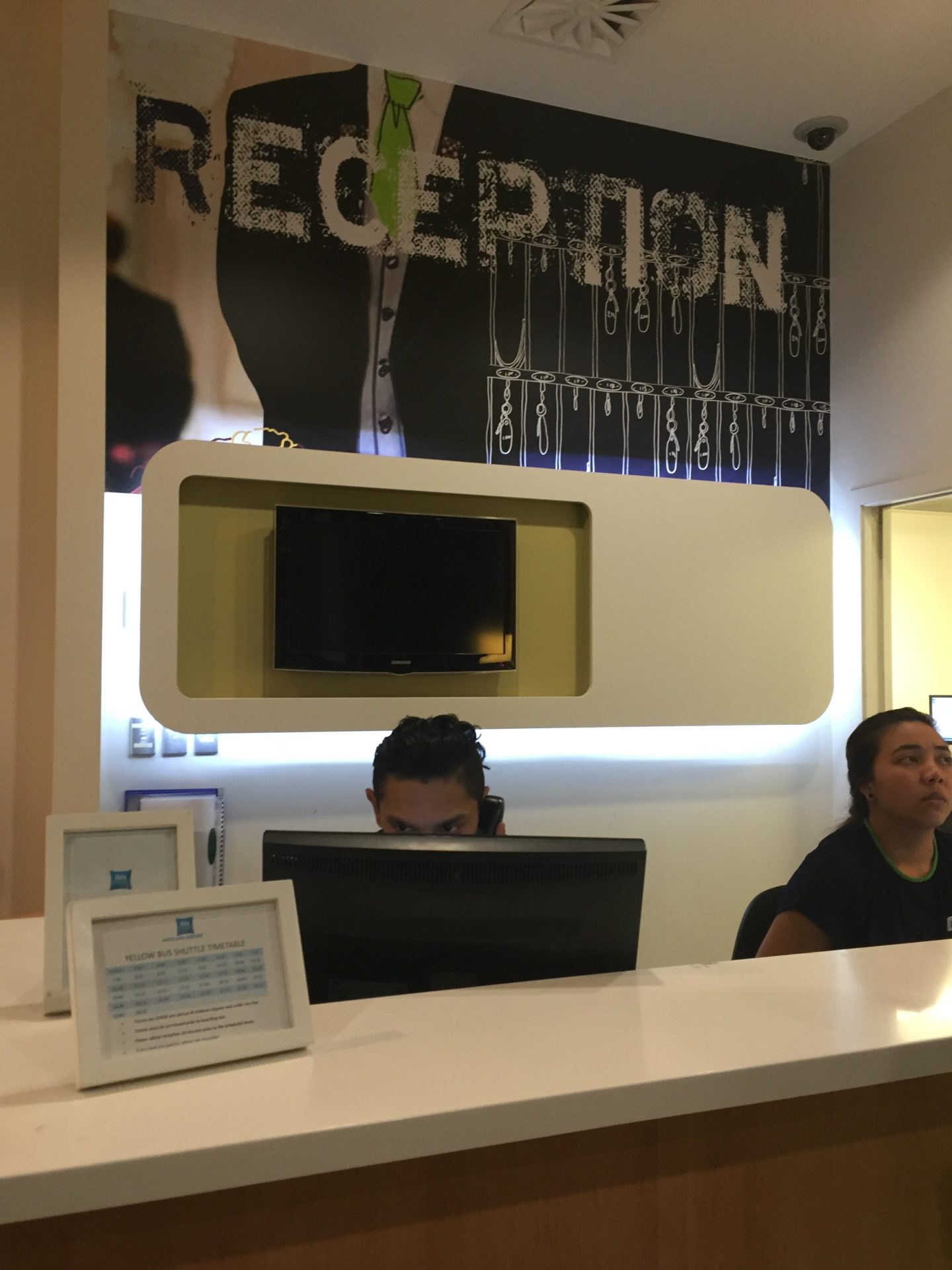 a couple of people sitting at a reception desk