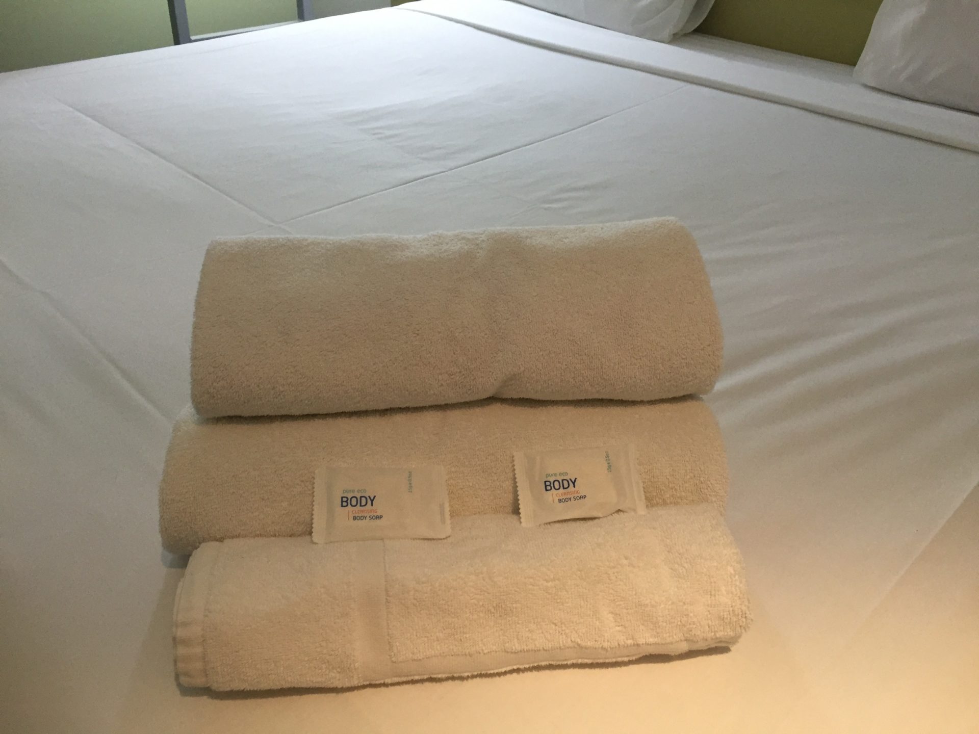 a stack of towels on a bed