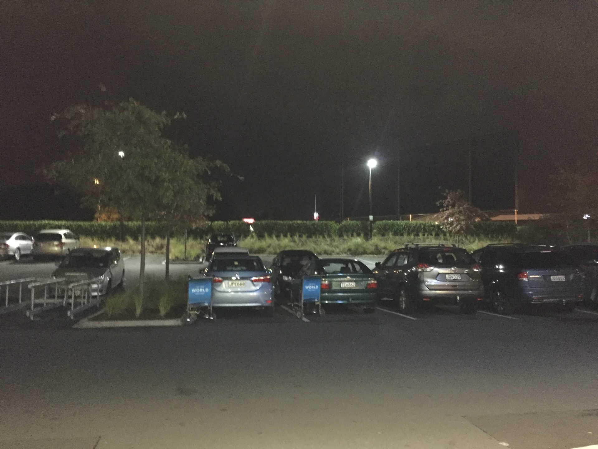 a group of cars in a parking lot at night