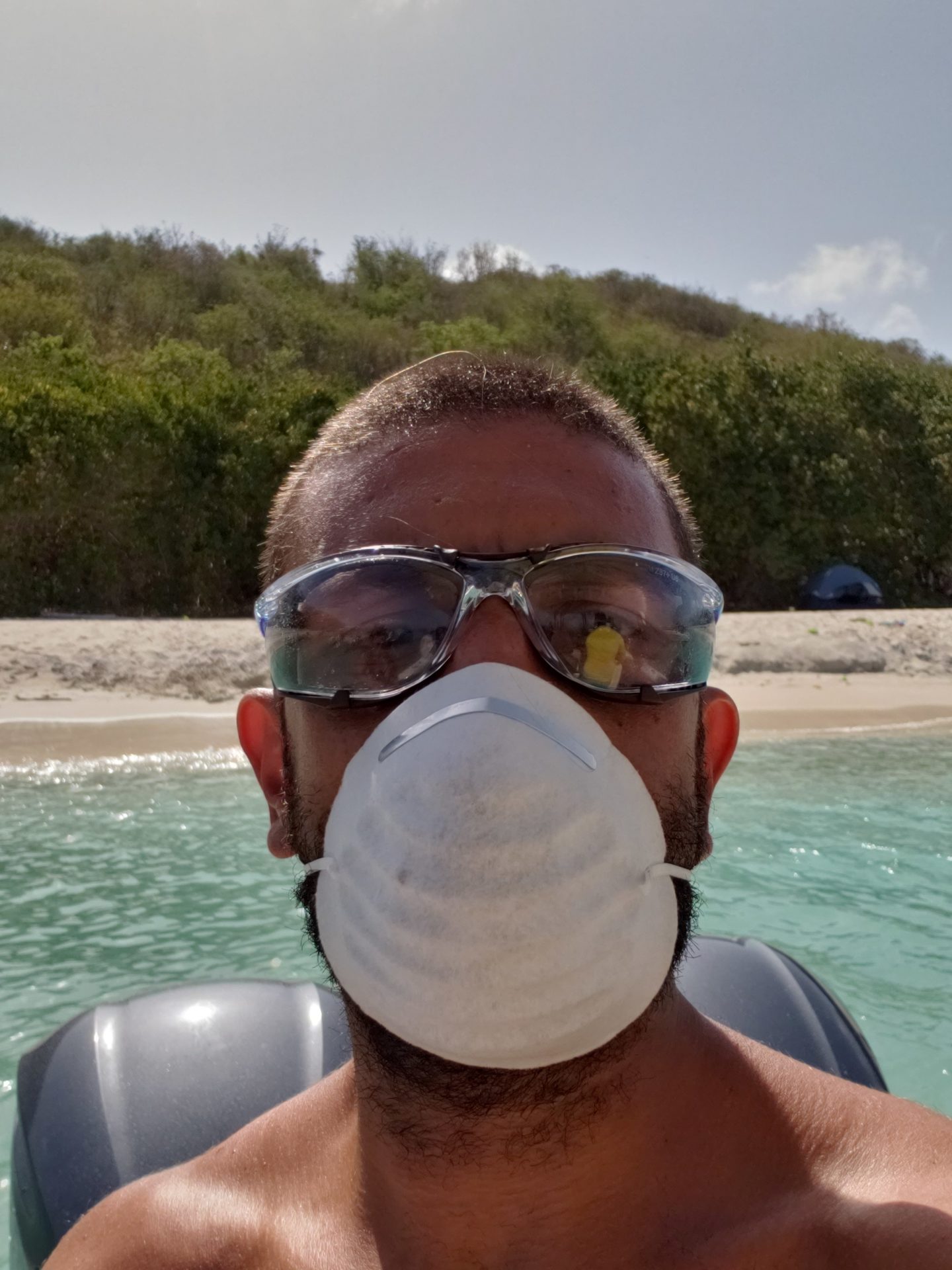 a man wearing a mask and goggles on a boat