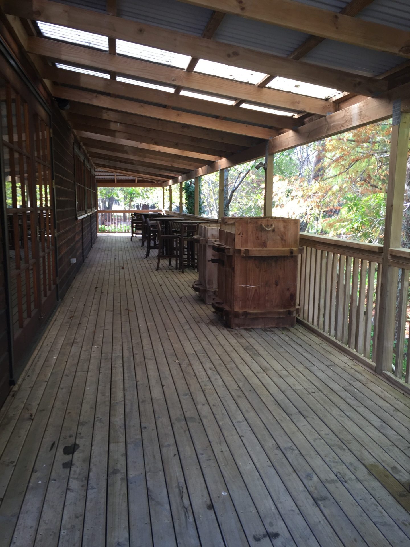 a wooden deck with tables and chairs