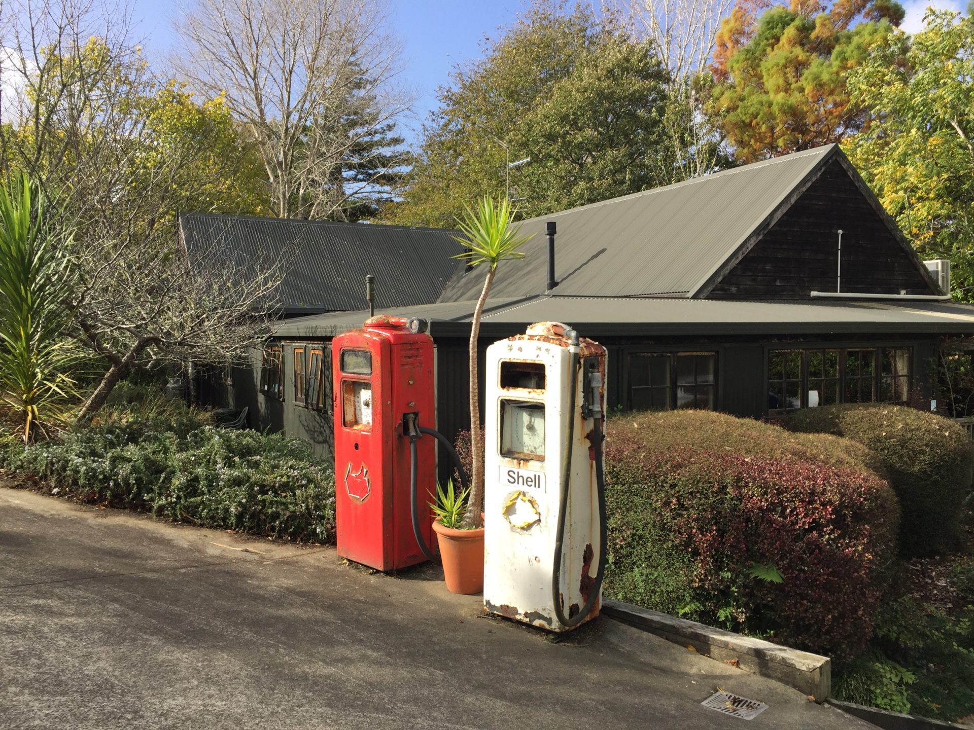 a couple of old gas pumps on a street