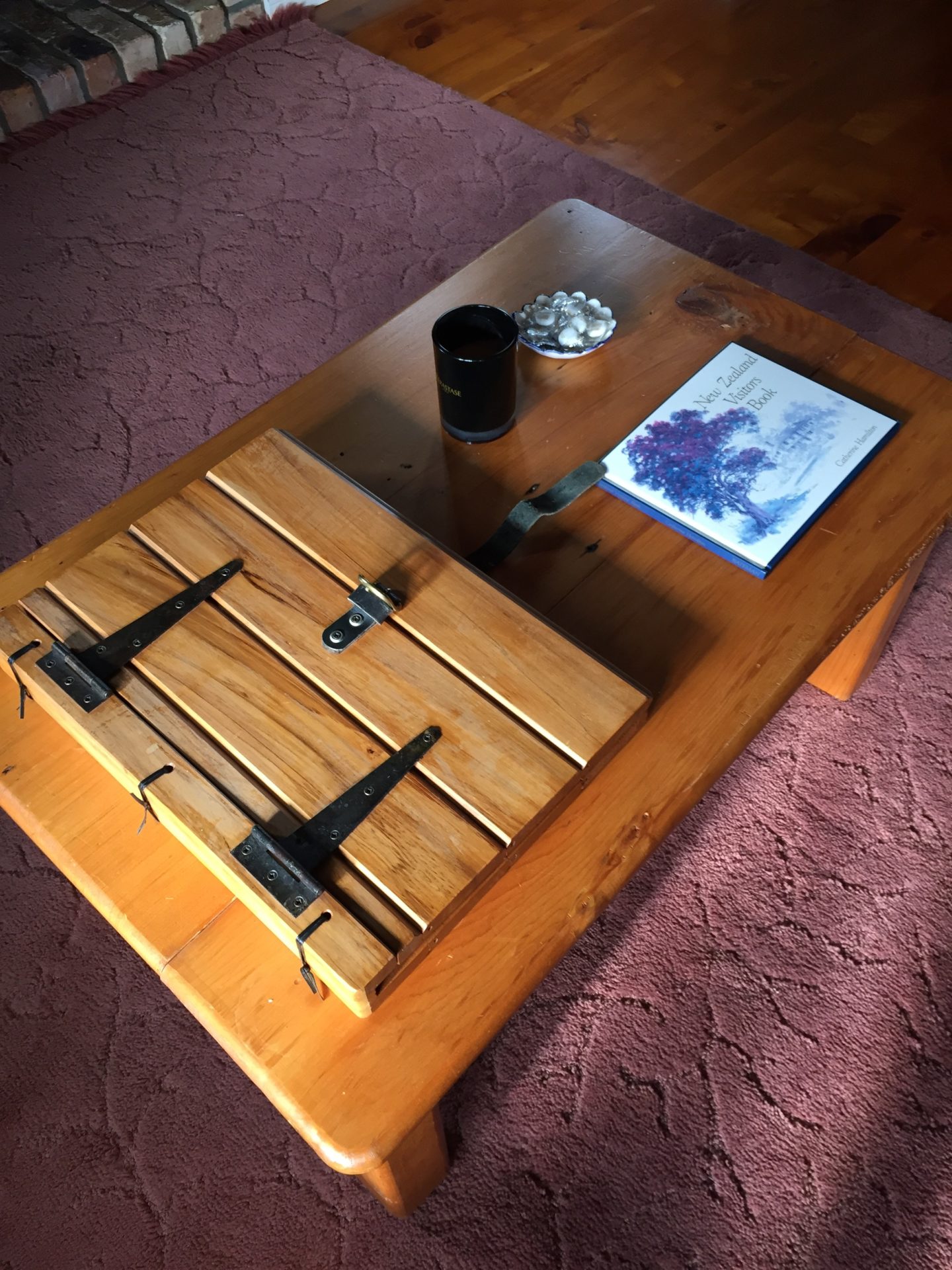 a wooden table with a book and a mug on it