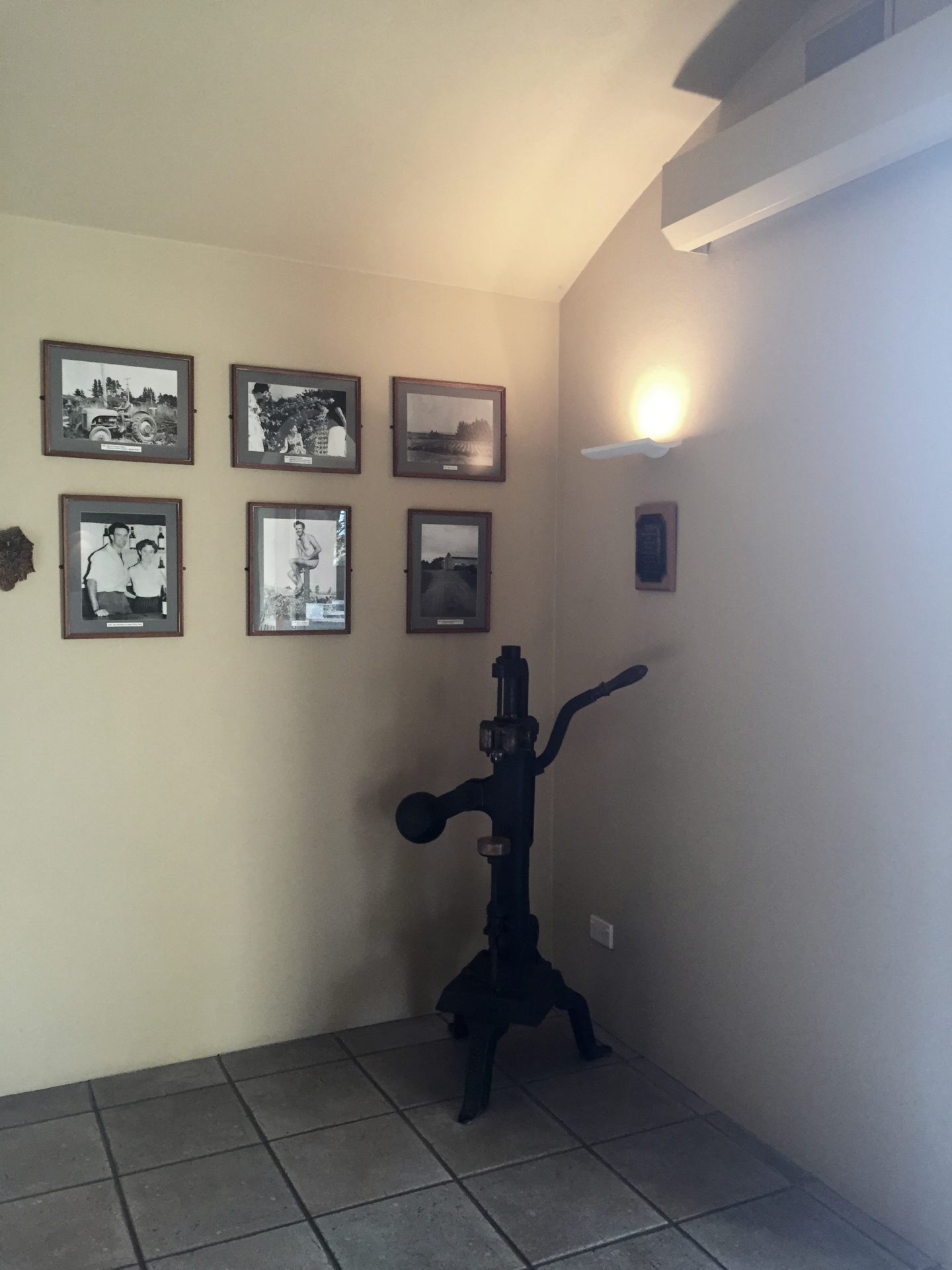a black pipe in a room with pictures on the wall