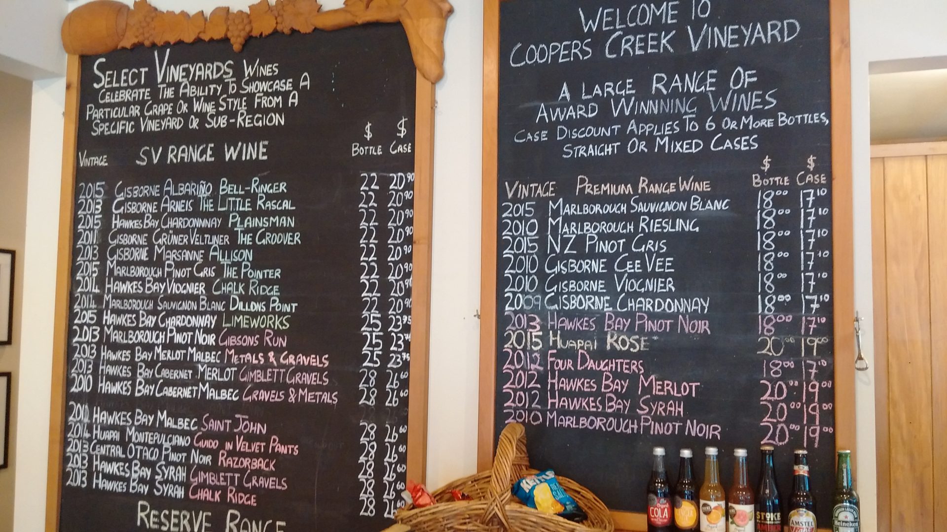 a chalkboard with a list of wine and bottles