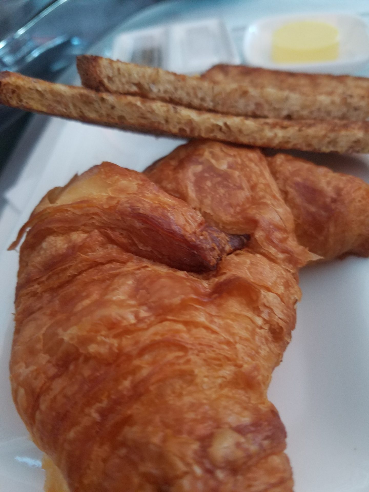 a croissant and toast on a plate