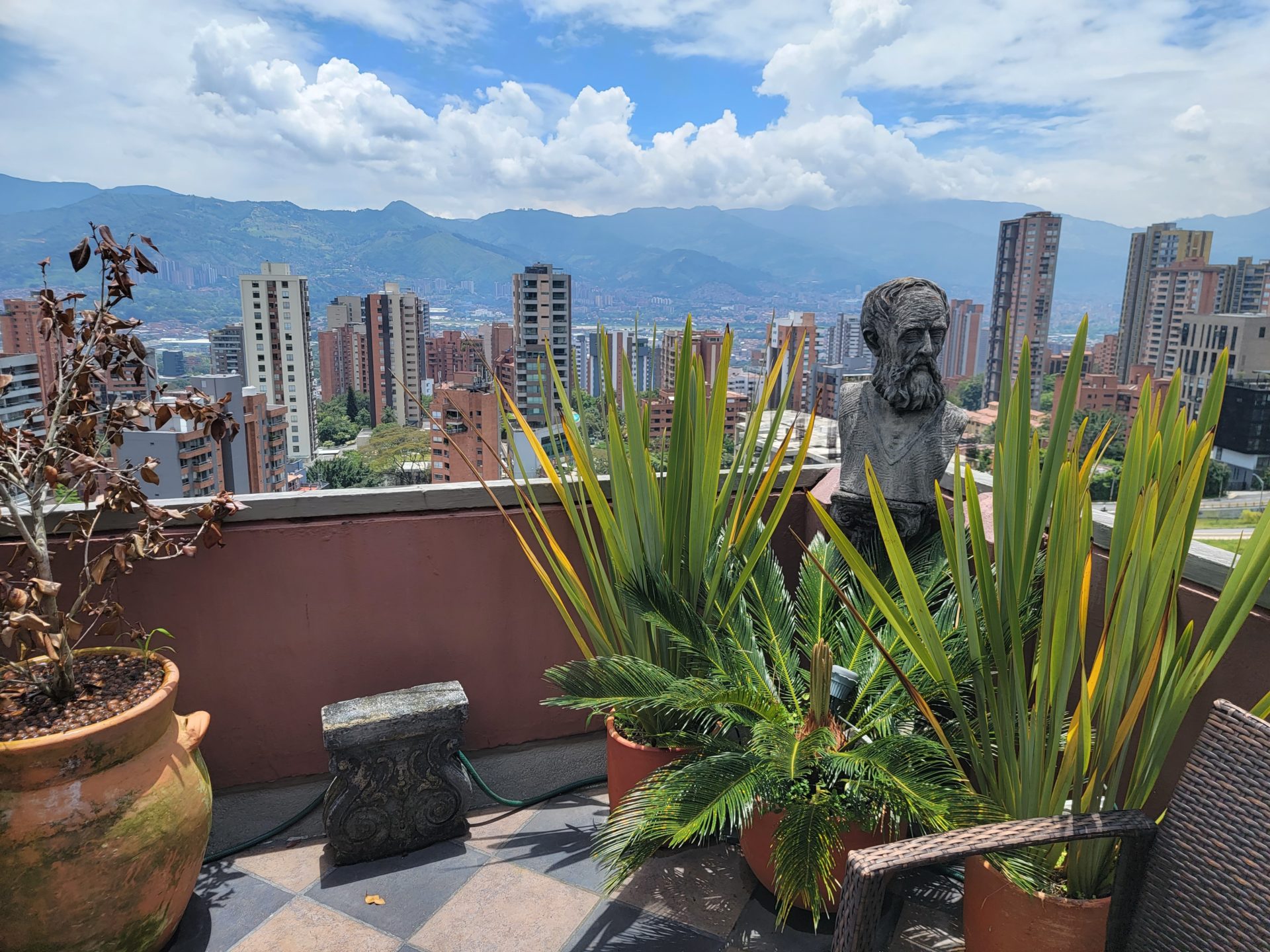 a statue on a rooftop overlooking a city