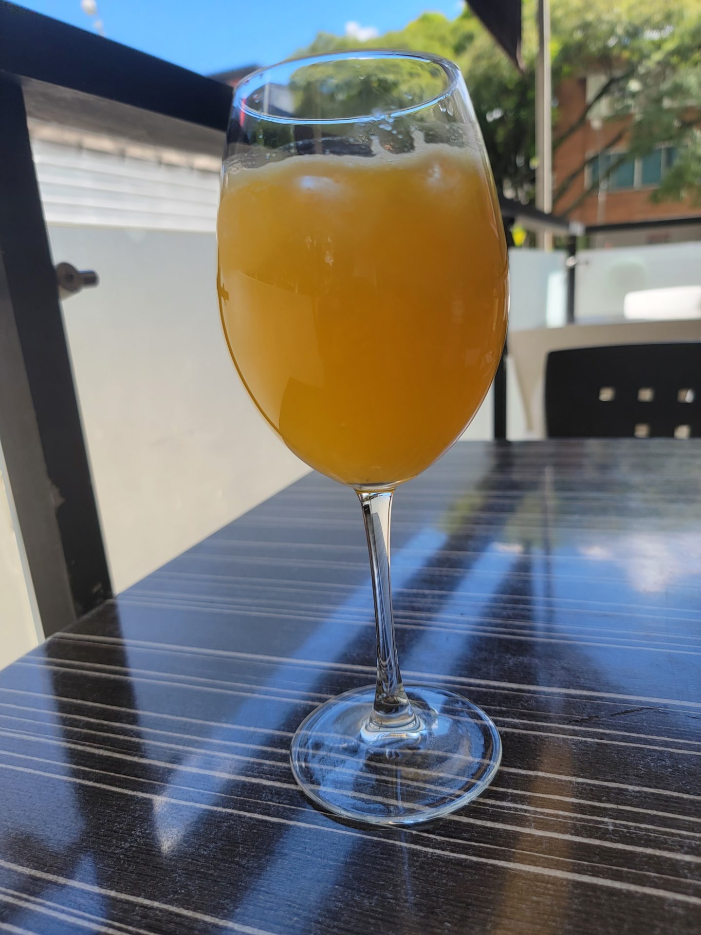 a glass of orange liquid on a table