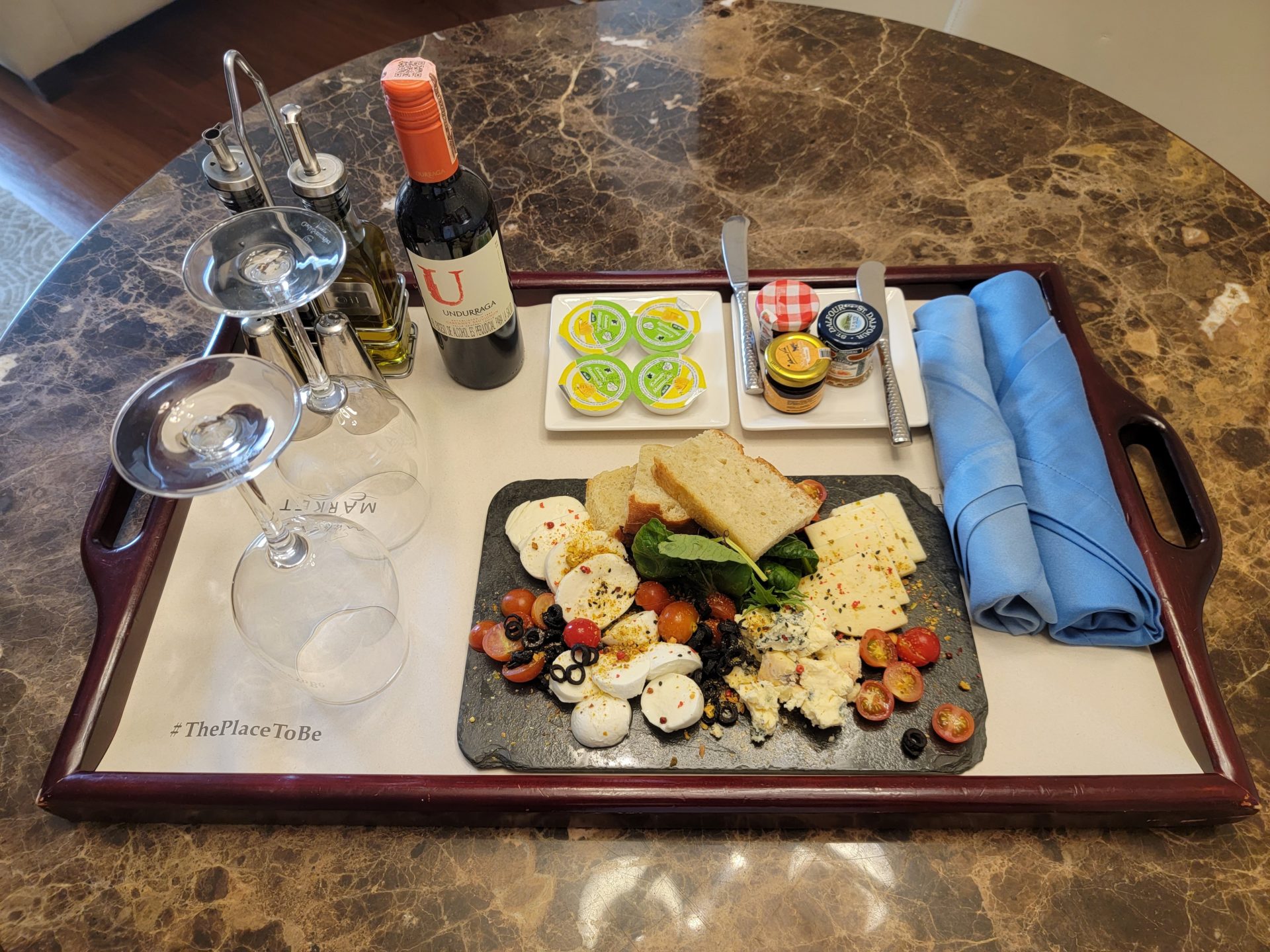 a tray with food and wine on it