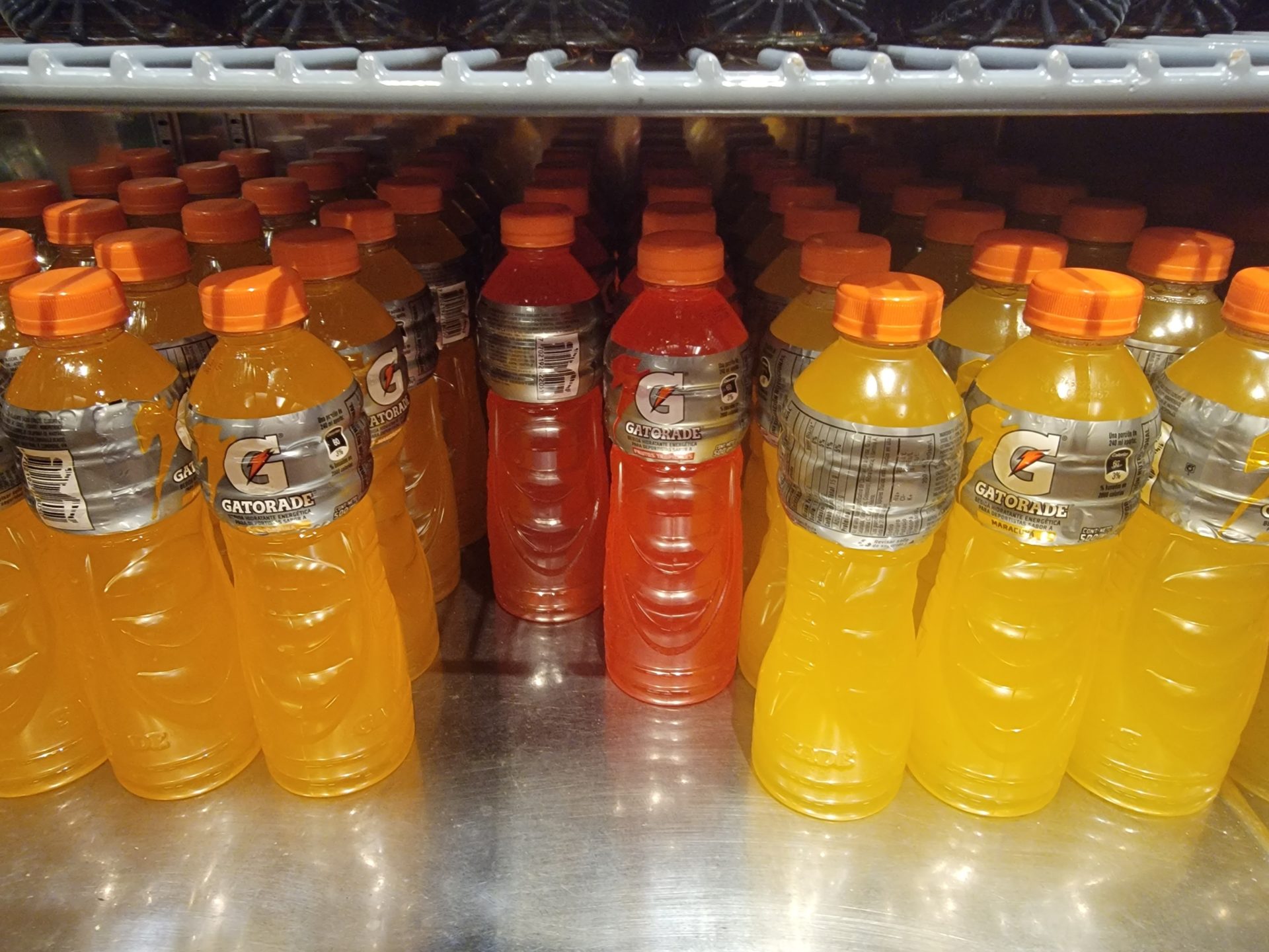 a group of bottles of orange and red liquid