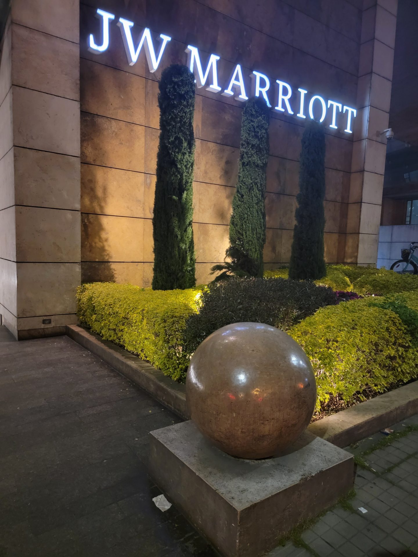 a stone ball in front of a building