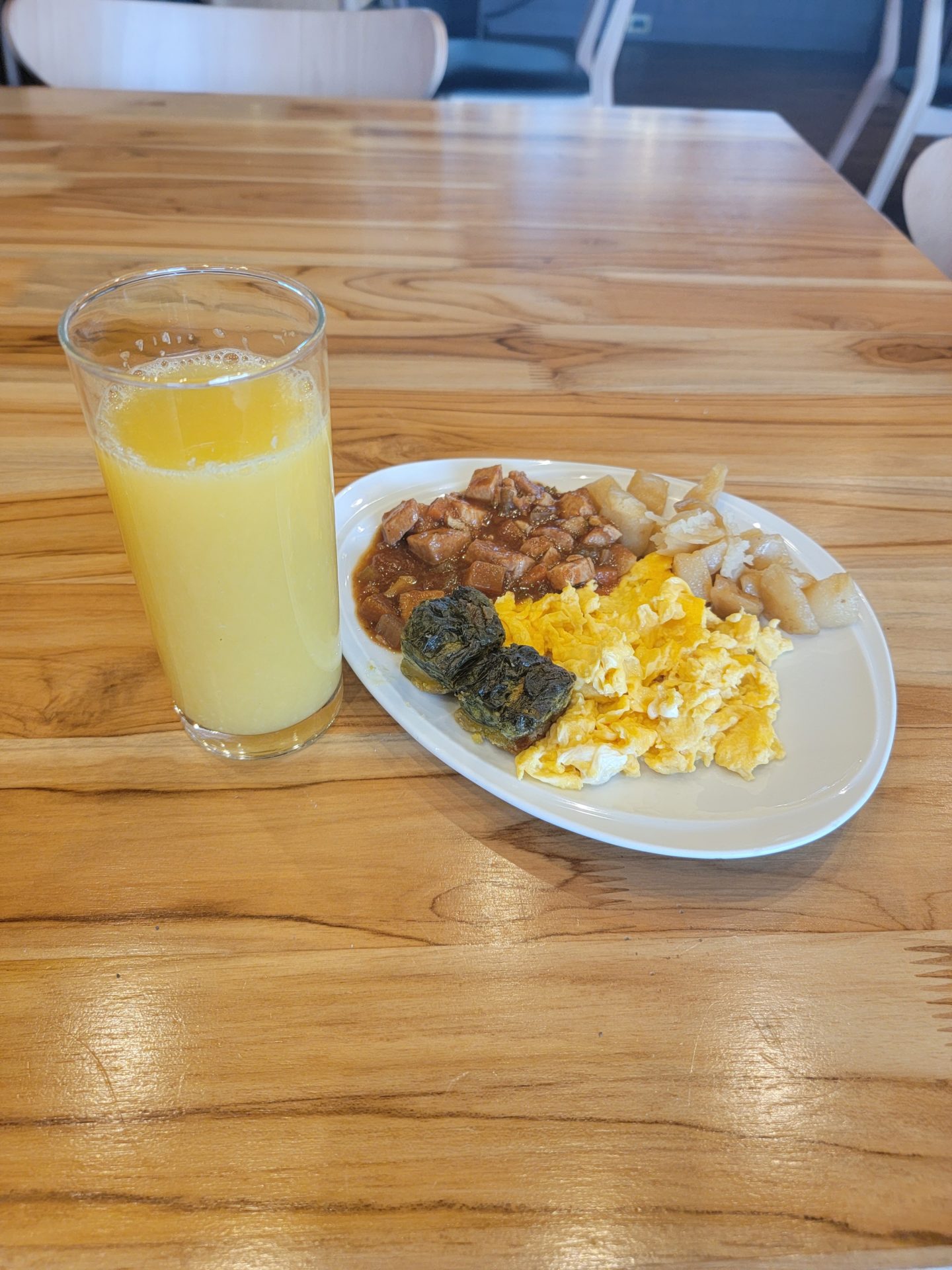 a plate of food and a glass of juice on a table