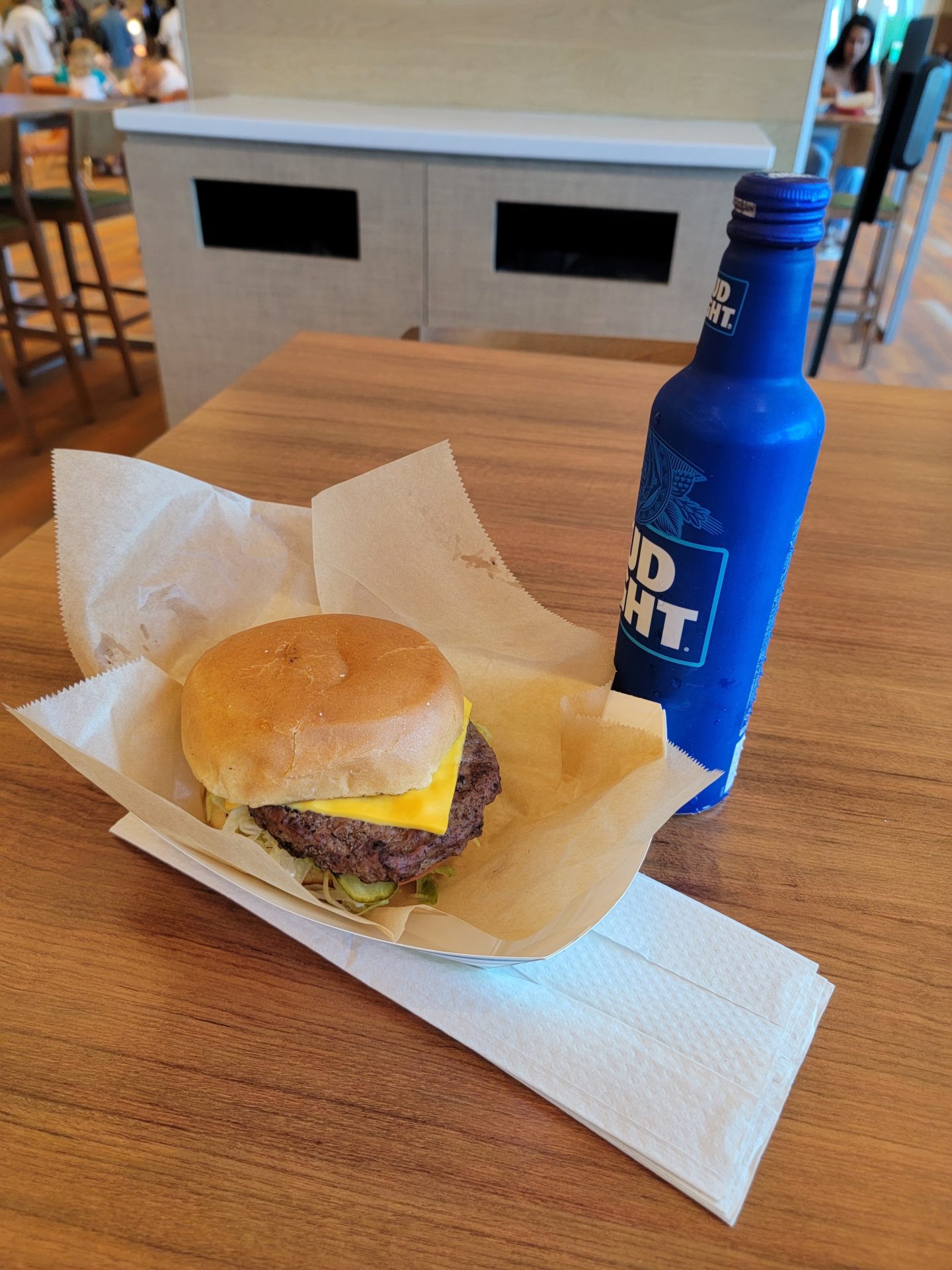 a burger and a bottle on a table