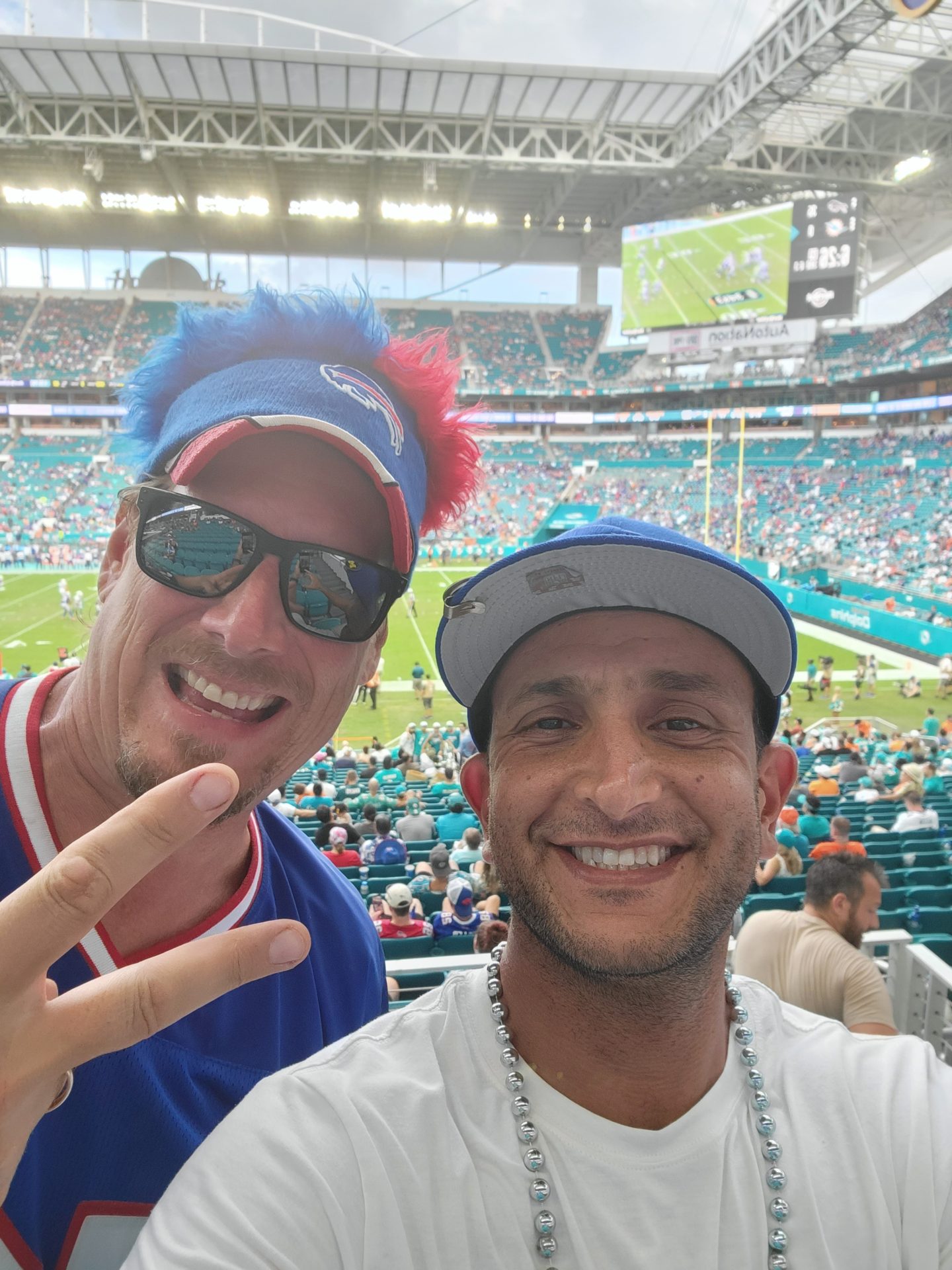 two men taking a selfie in a stadium