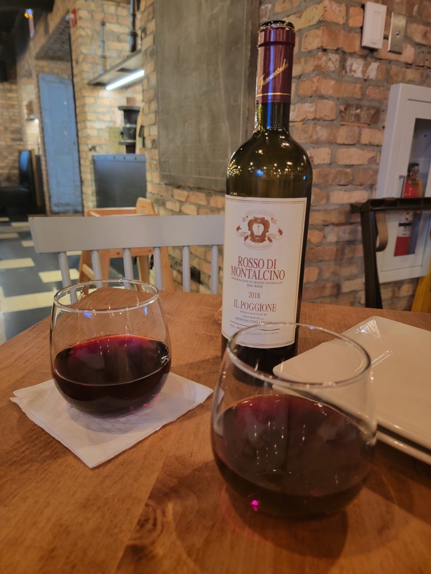 a bottle of wine and two glasses of wine on a table