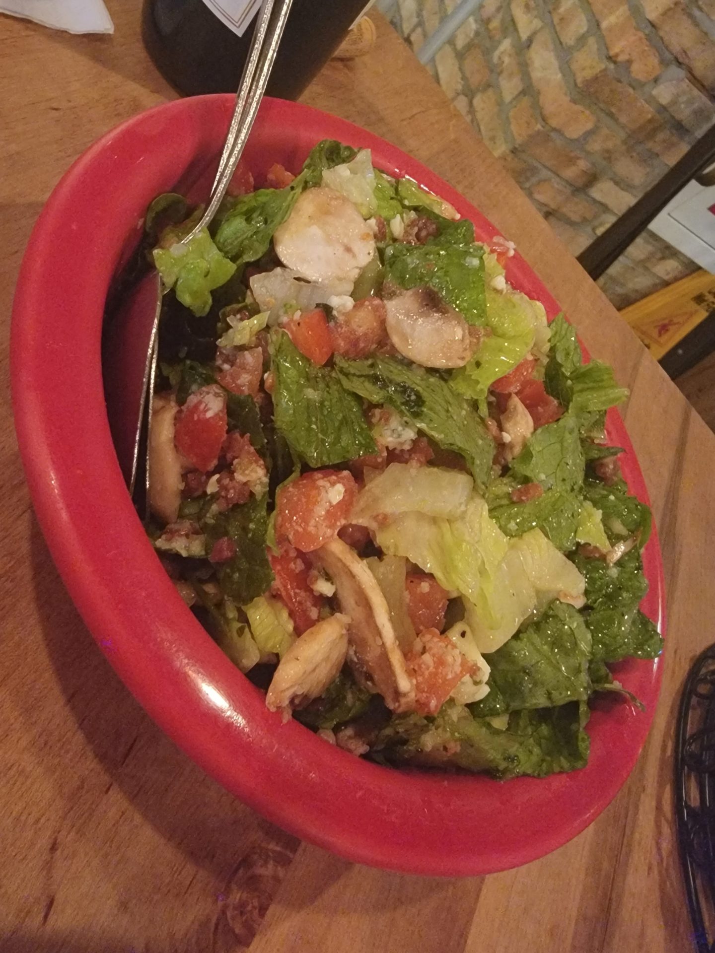a bowl of salad with a spoon