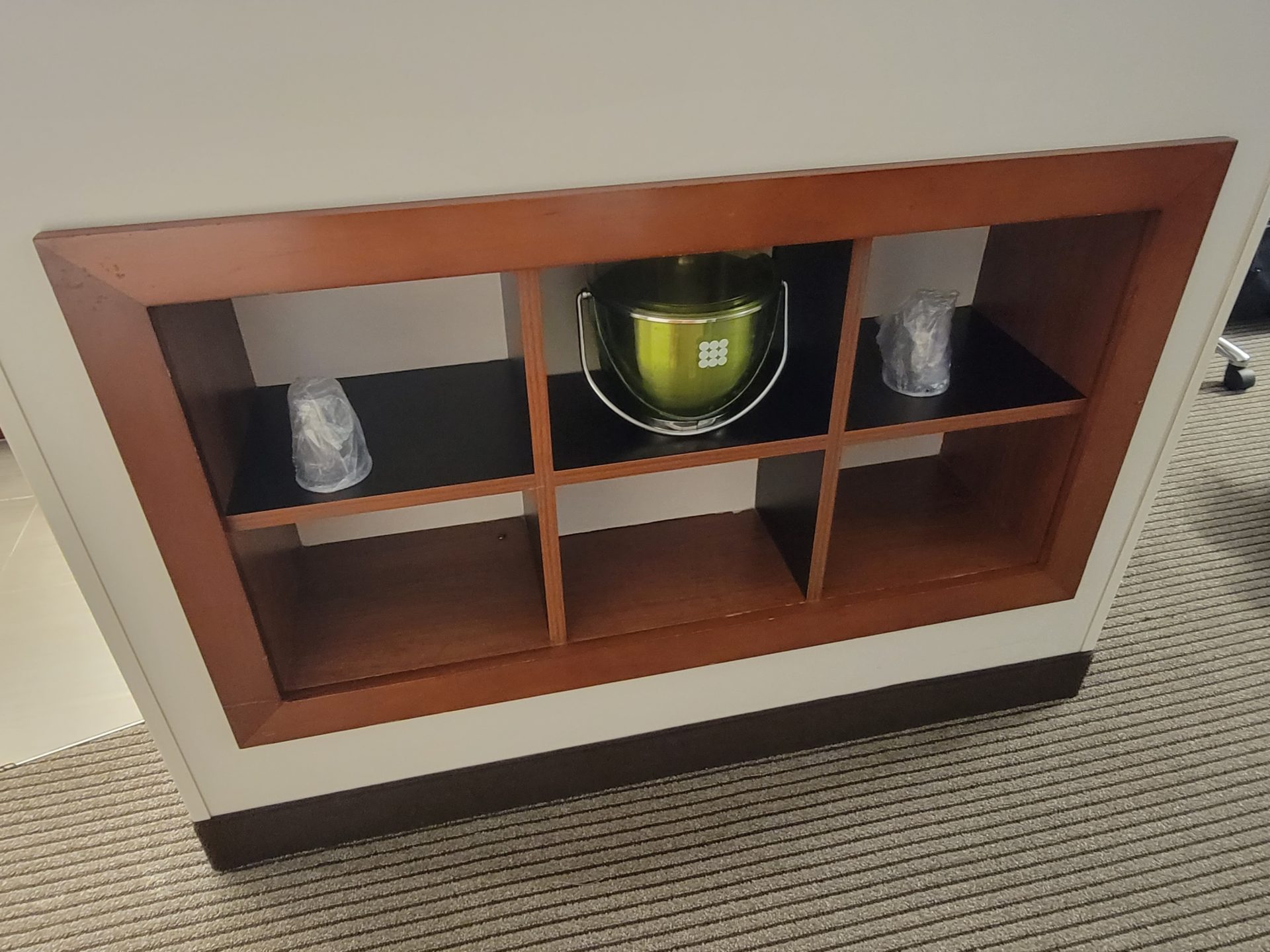 a shelf with a bucket and a bucket on it