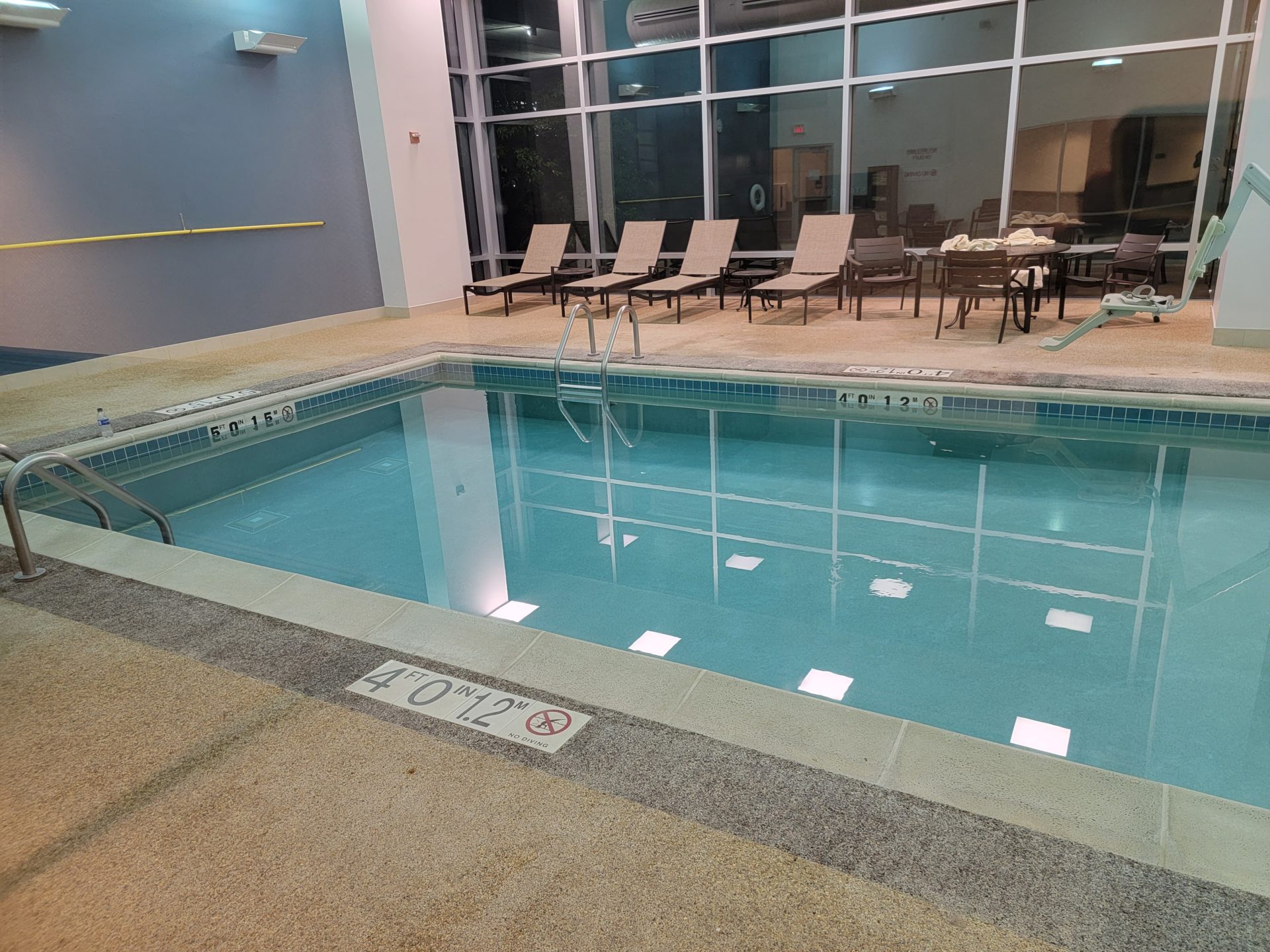 a pool with chairs in the background
