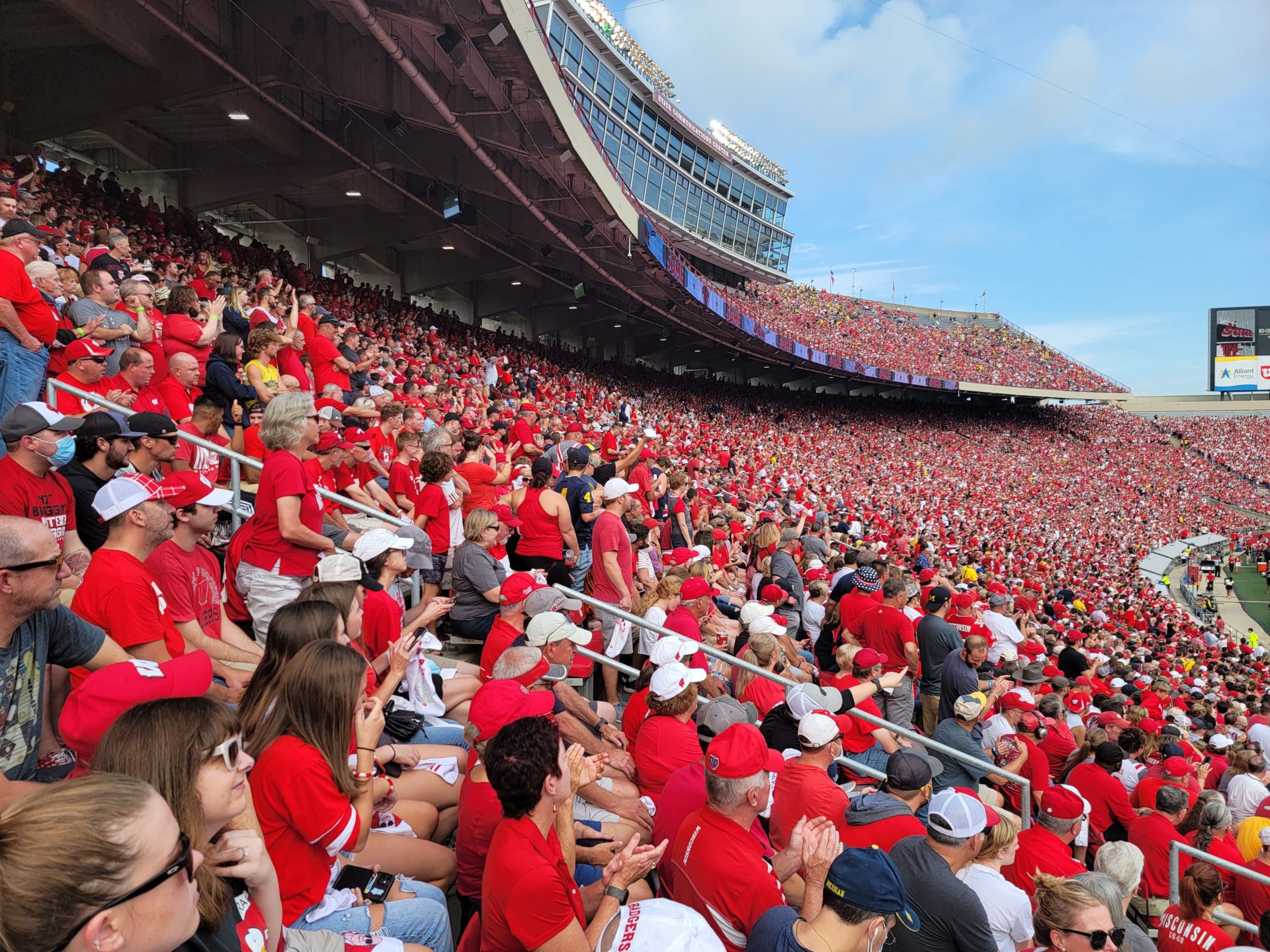 a crowd of people in red shirts in a stadium