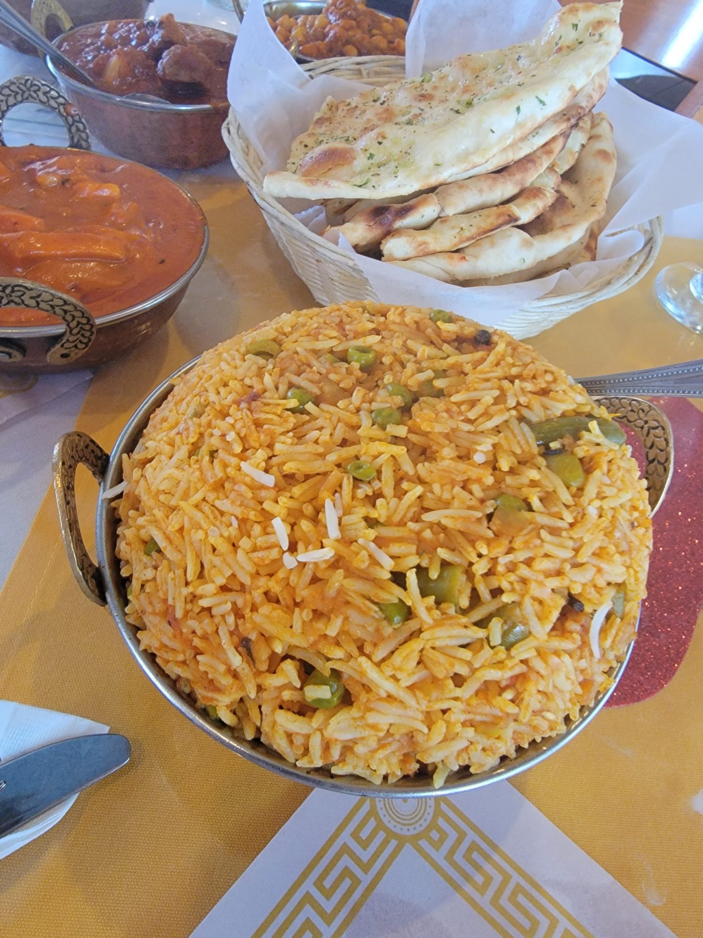 a bowl of rice and a bowl of naan bread