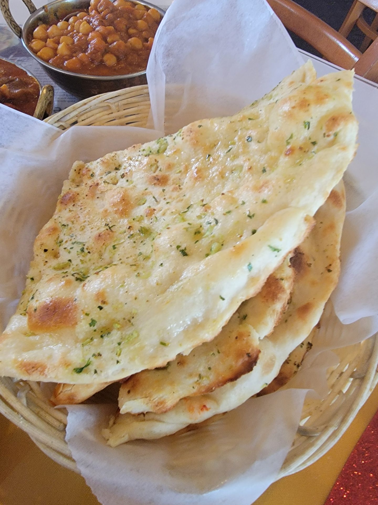 a stack of flat bread in a basket