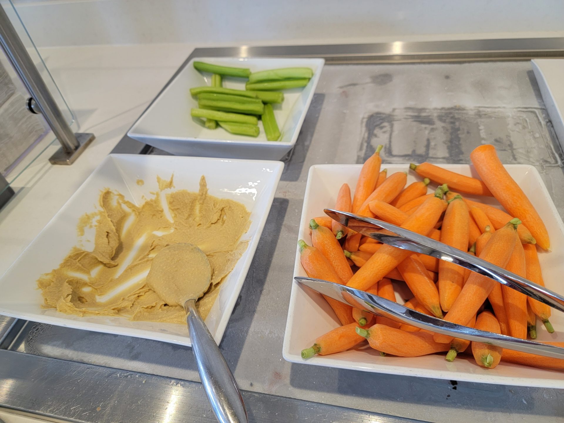 a plate of carrots and a spoon in a bowl