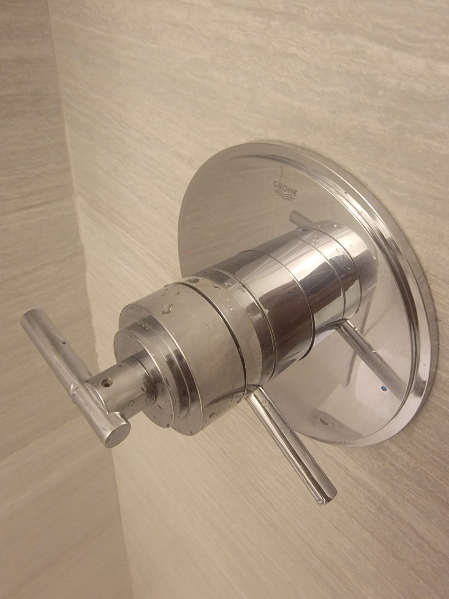 a silver faucet in a bathroom