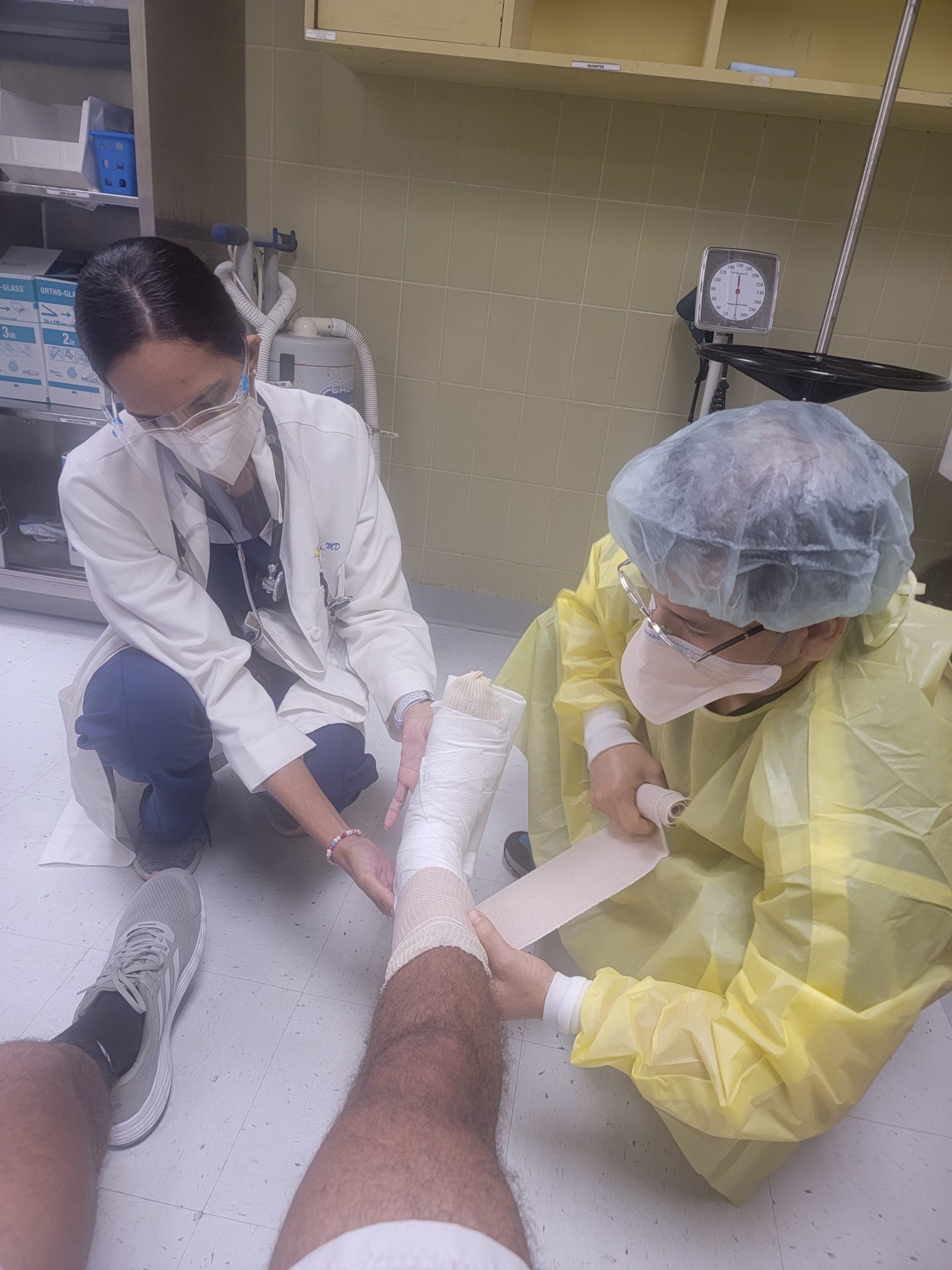 a doctor bandaging a patient's leg