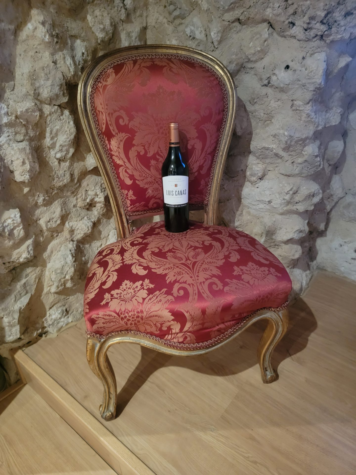a bottle of wine on a red chair