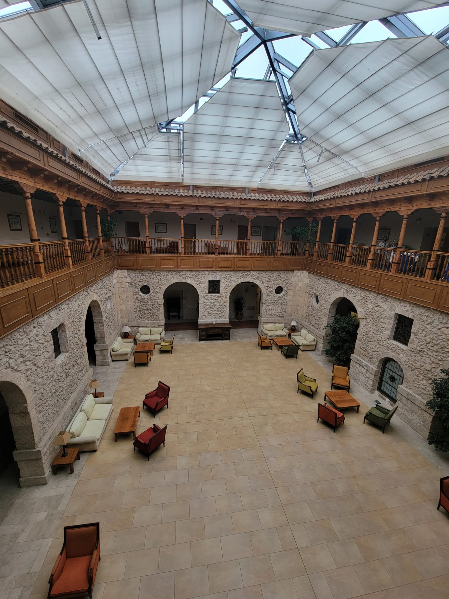 a room with a large stone building with a glass roof