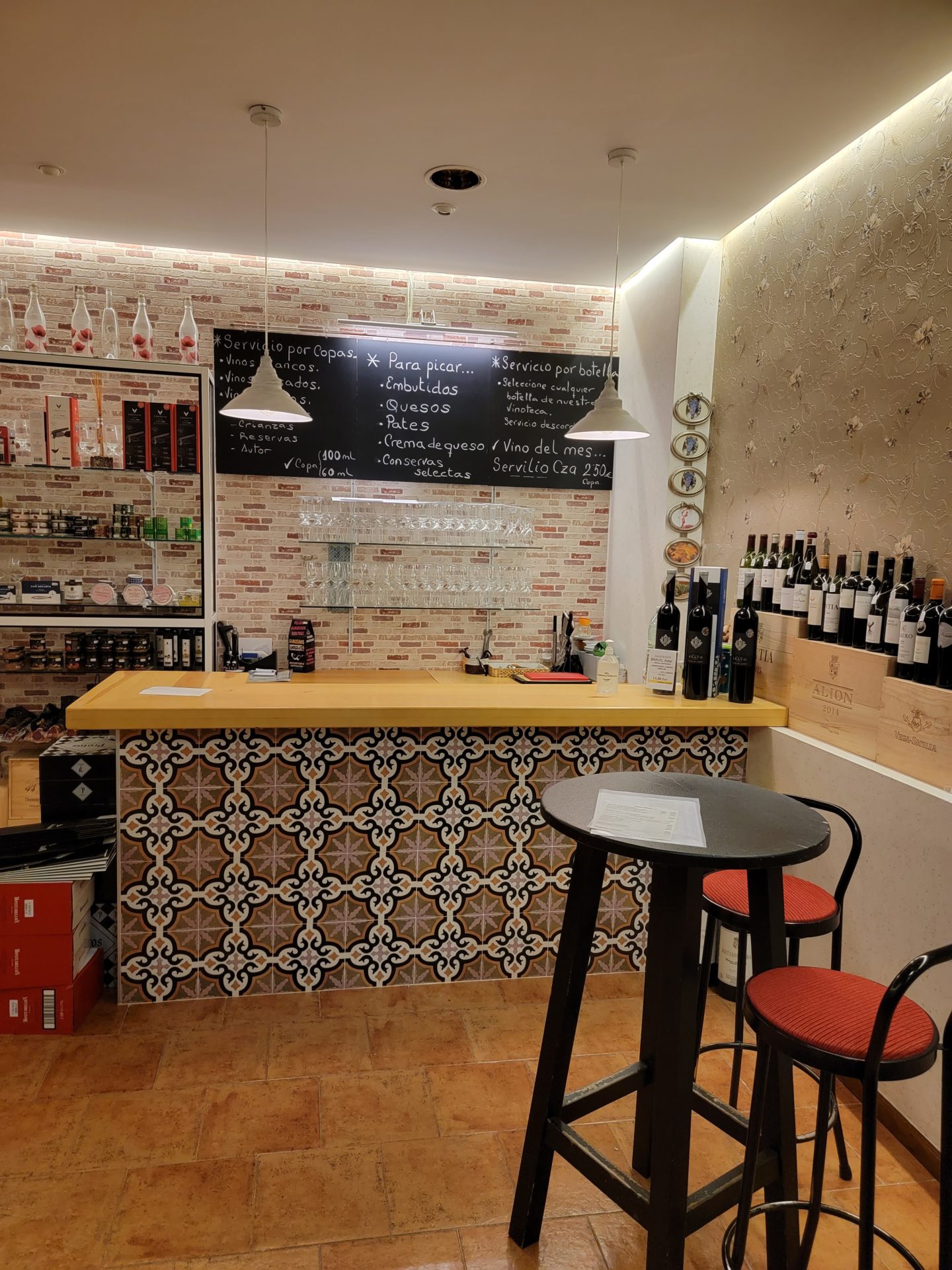 a bar with wine bottles and shelves