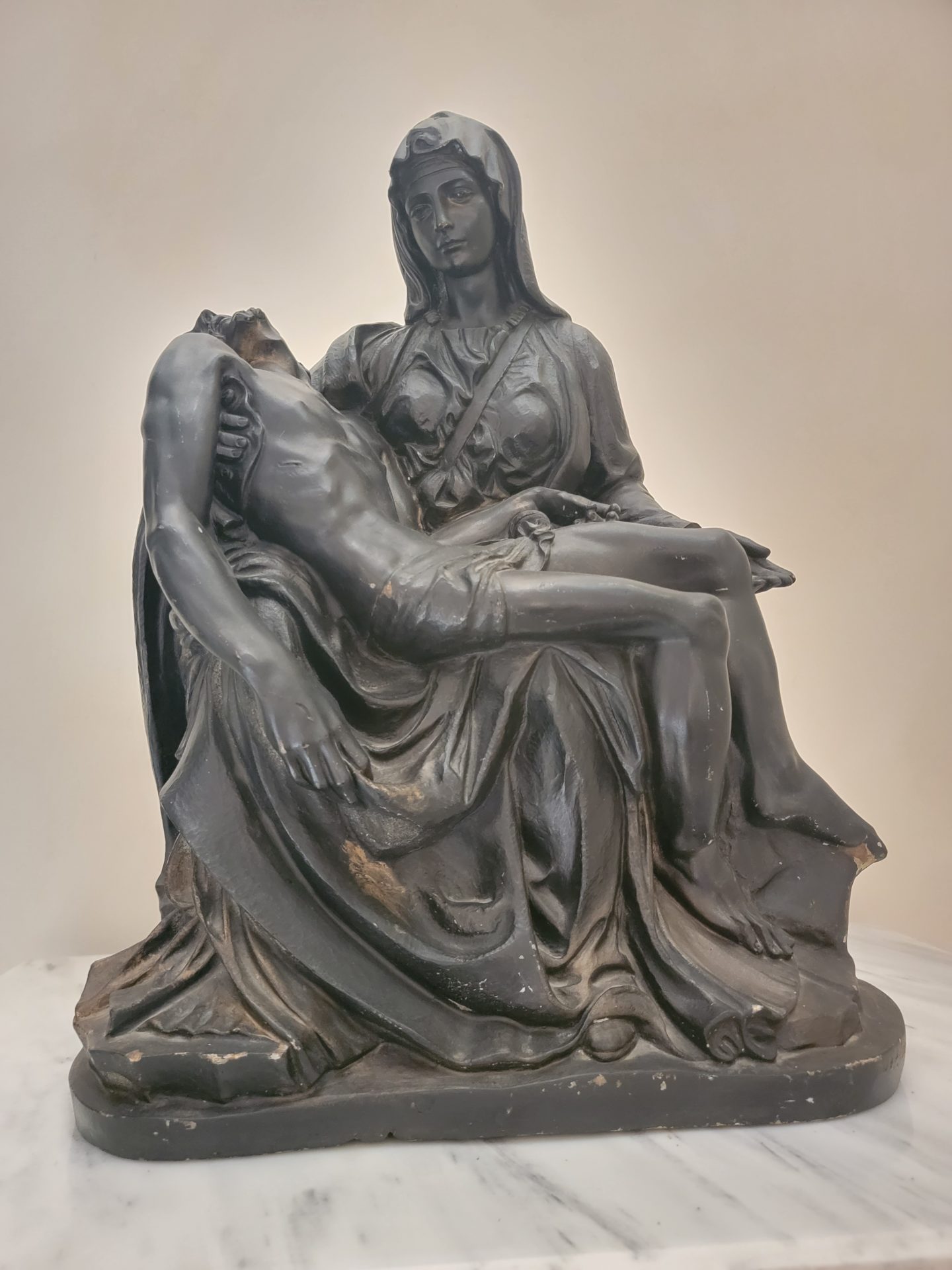 a statue of a woman holding a man