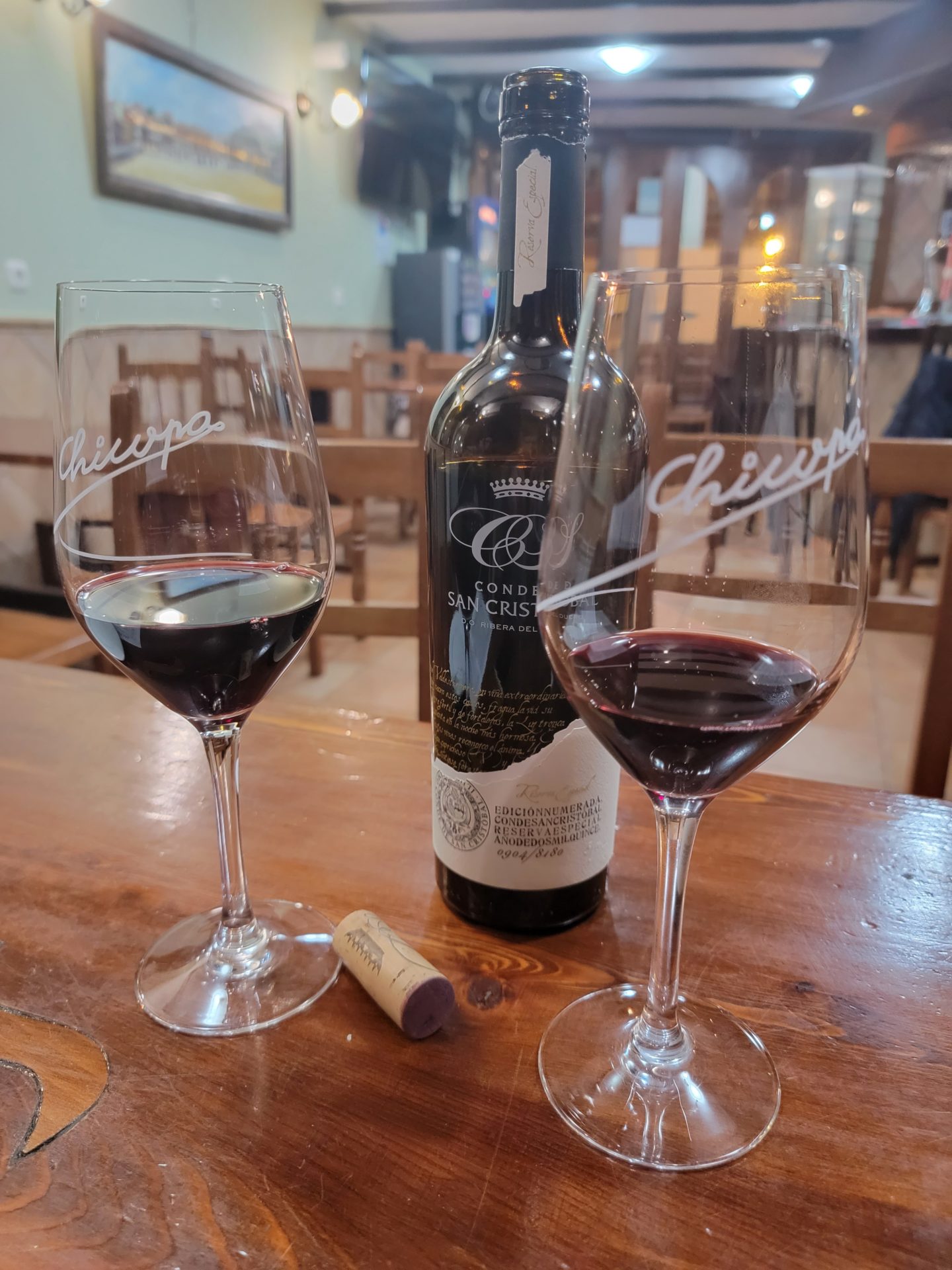 a bottle of wine next to wine glasses