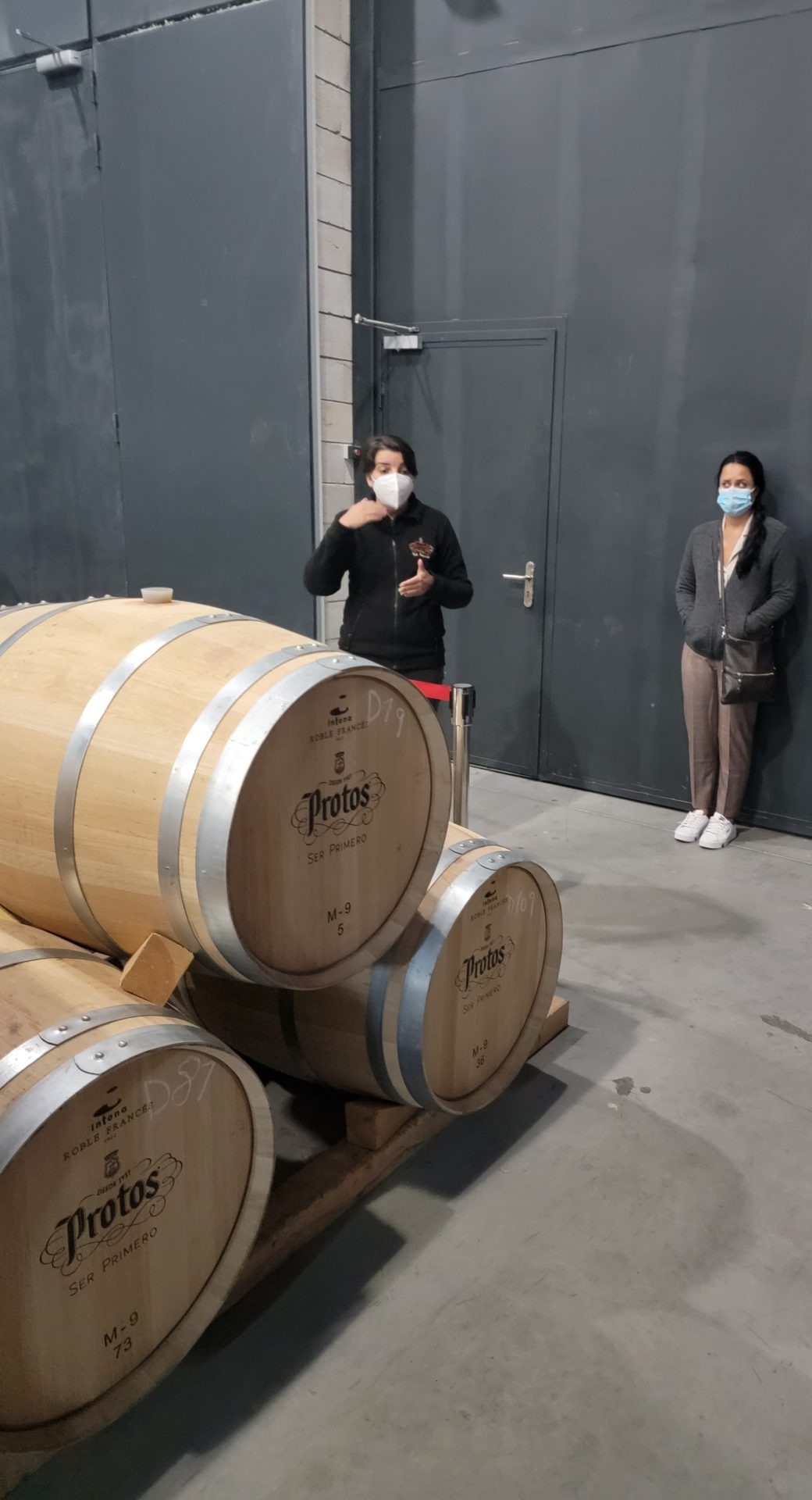 a group of people standing next to barrels