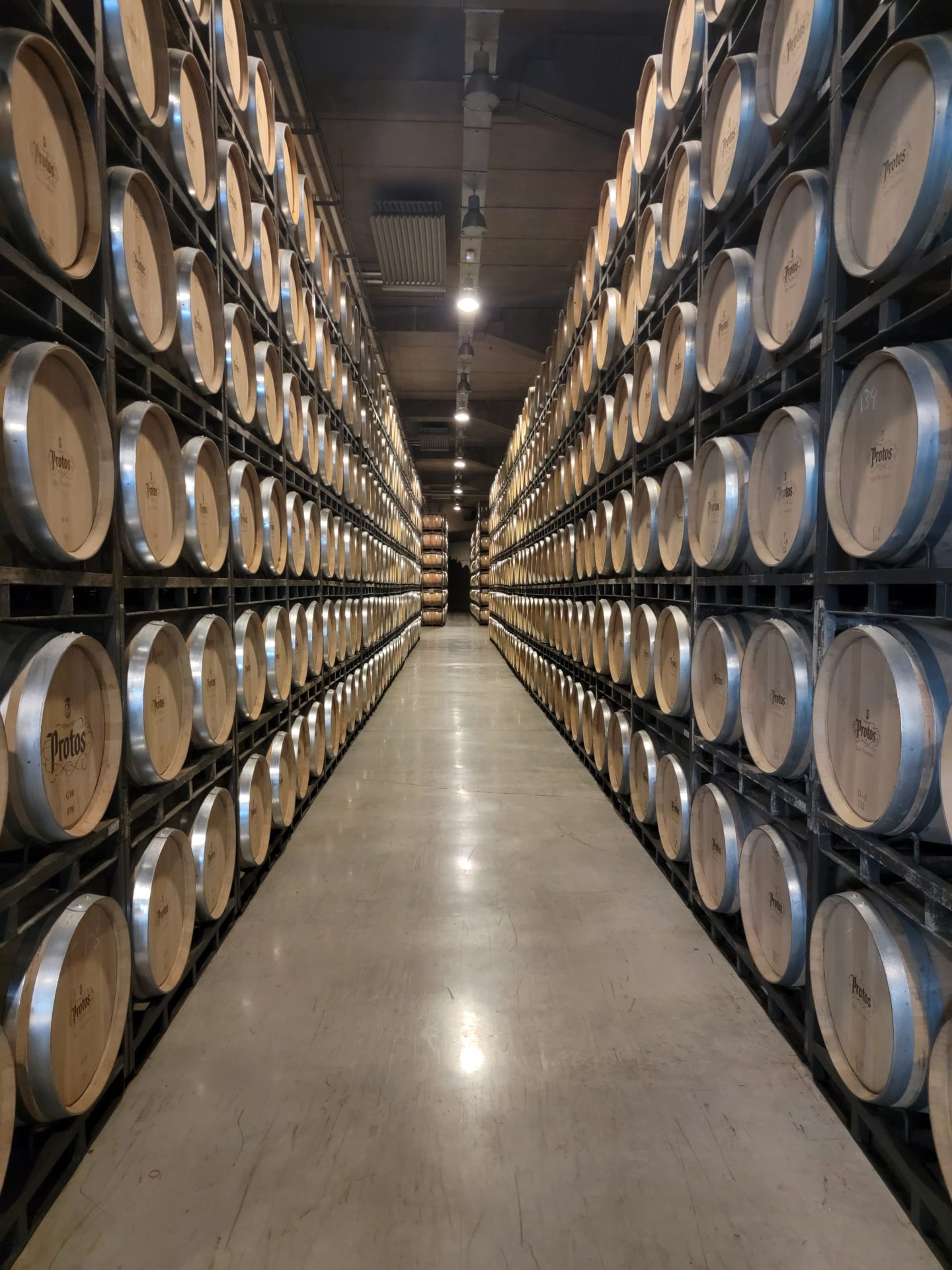 a rows of barrels in a warehouse
