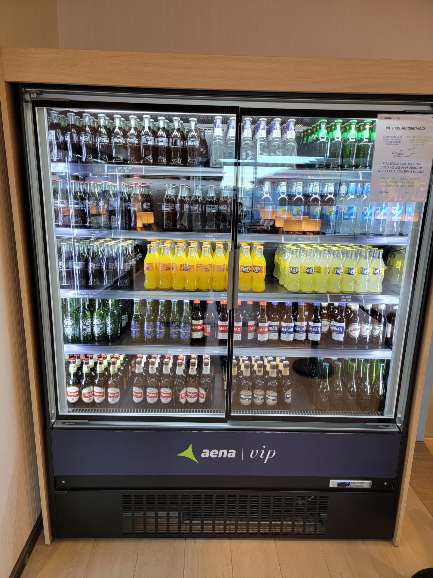 a refrigerator with bottles of soda and drinks